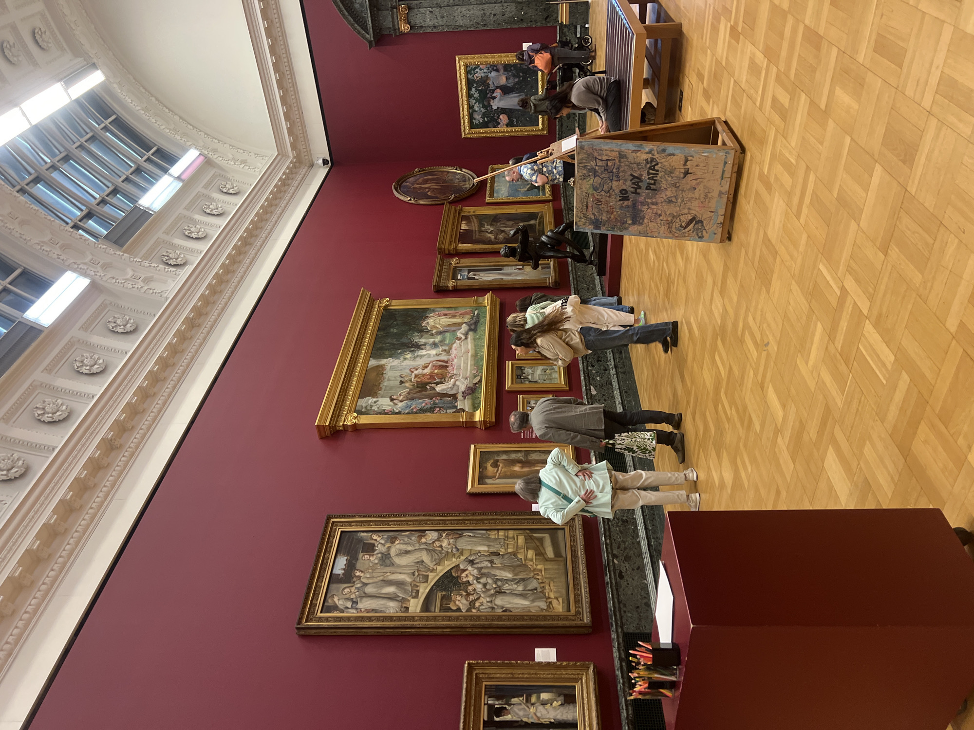Visitor documents classical paintings during London gallery tour