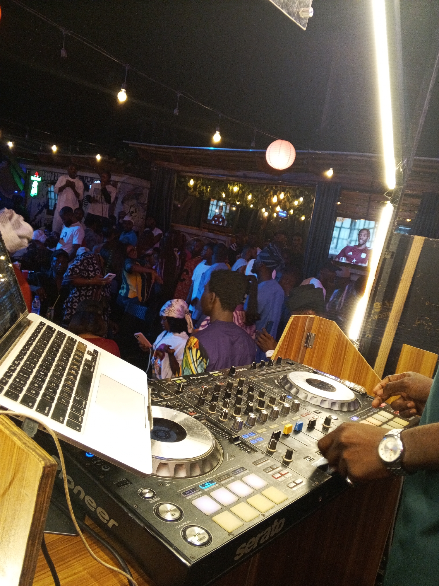 DJ performs at busy nightclub venue