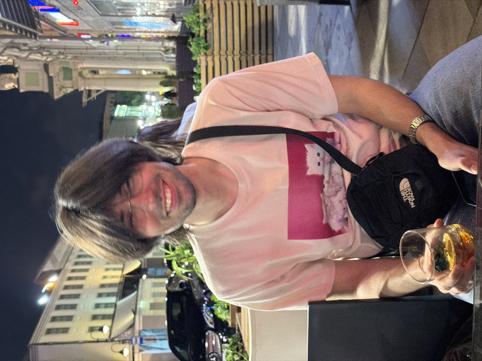 Man with drink spotted smiling in Moscow street scene