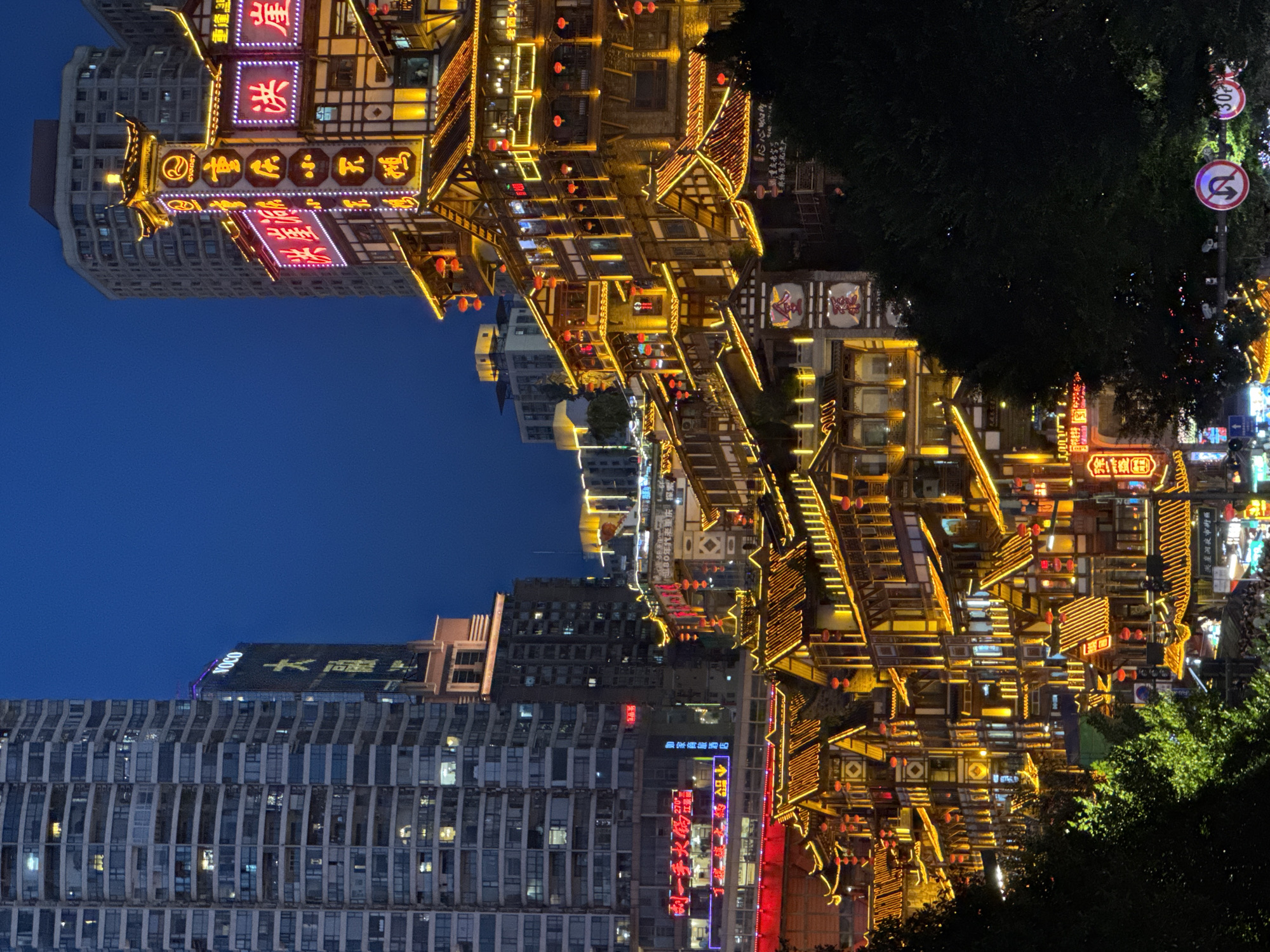 Chongqing's Hongyadong and riverfront bridge lit up at night