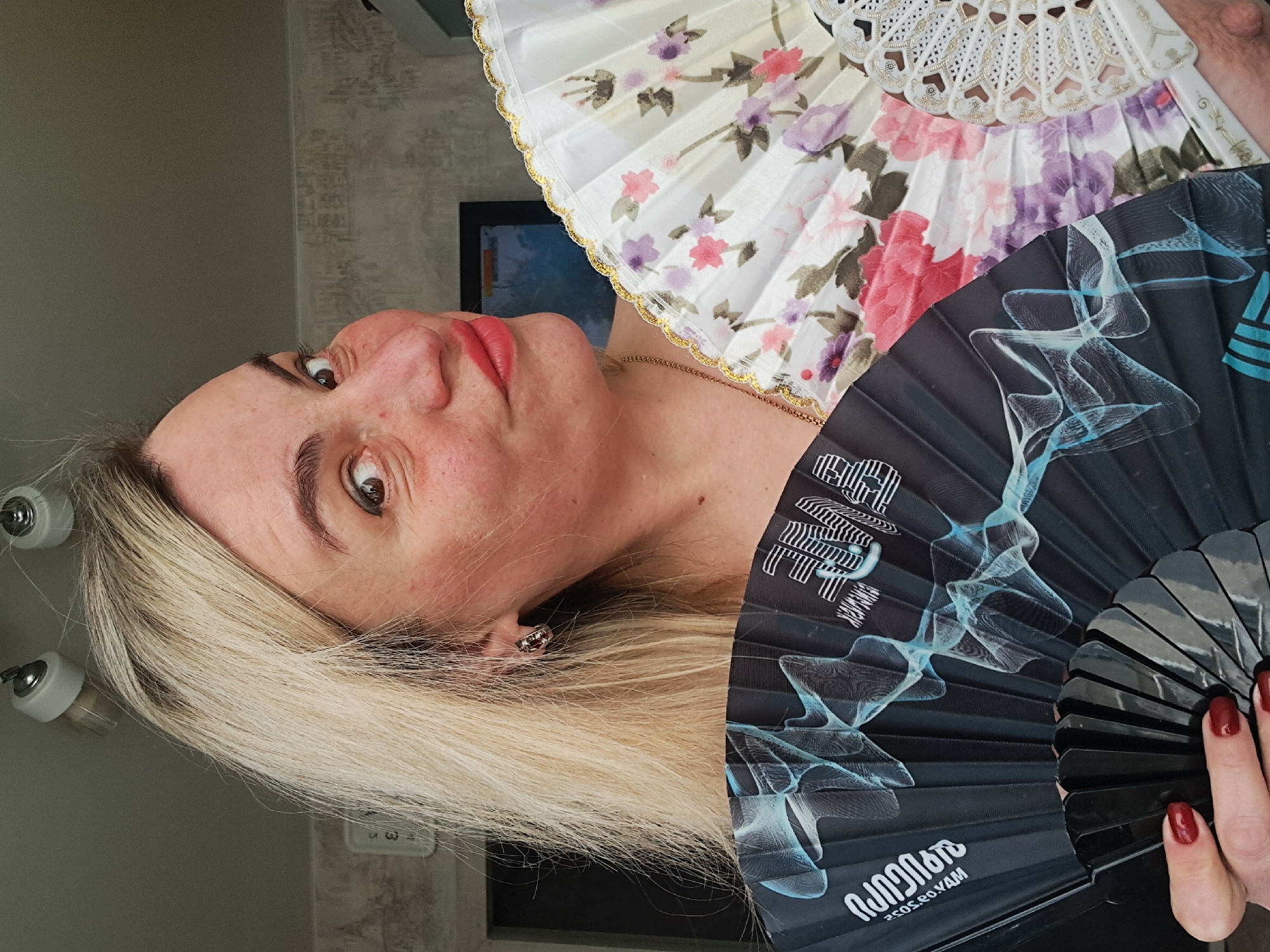 Woman displays decorative fans in Elektrostal, Russia