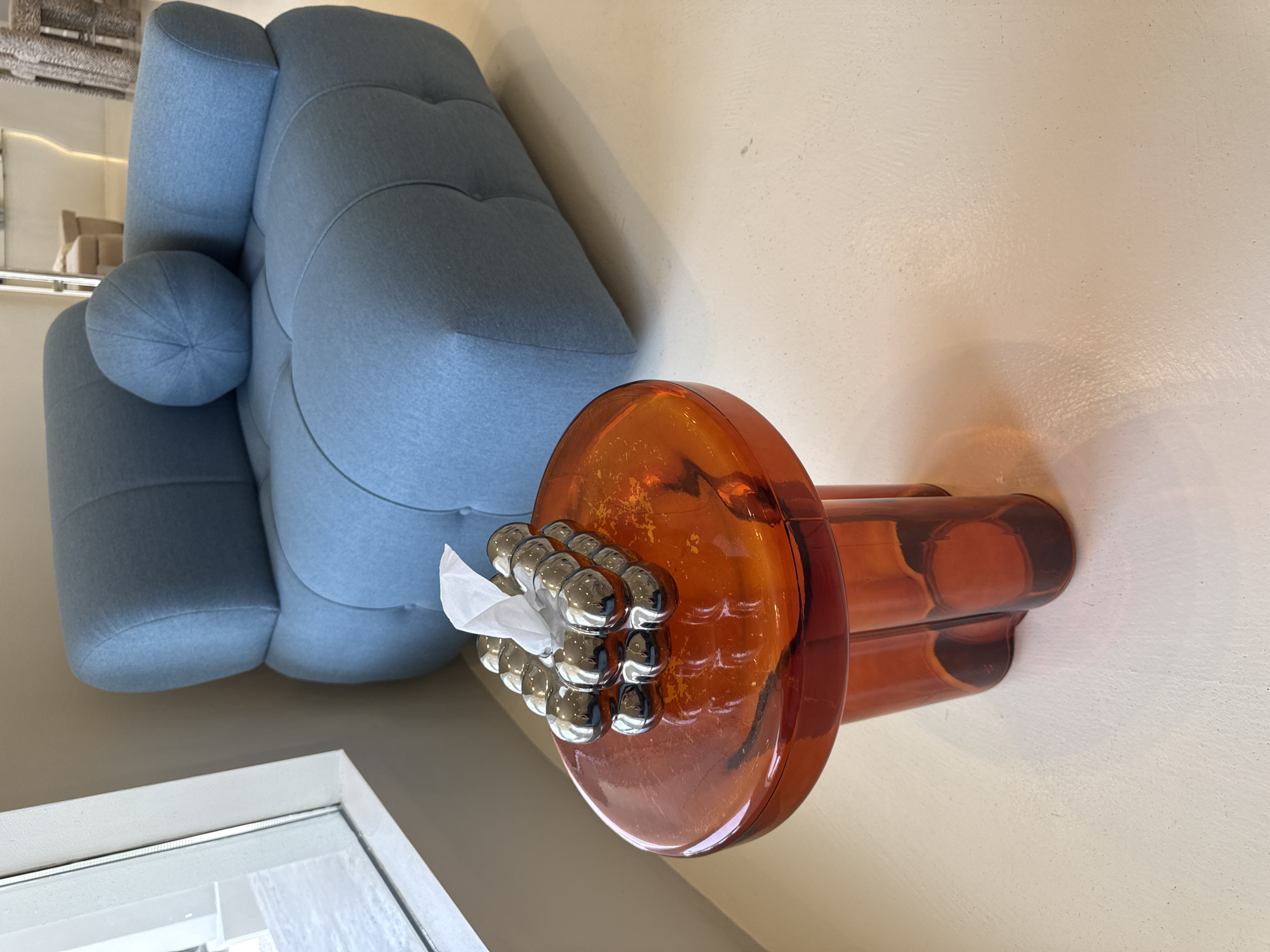 Contemporary interior space with orange glass object documented in Dubai