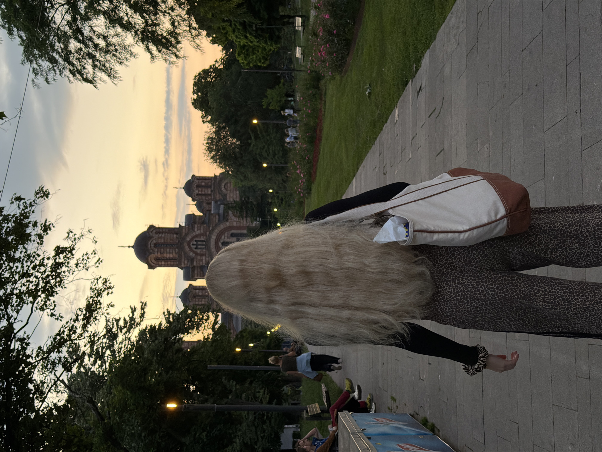 Woman walks near Saint Mark's Church in Belgrade evening