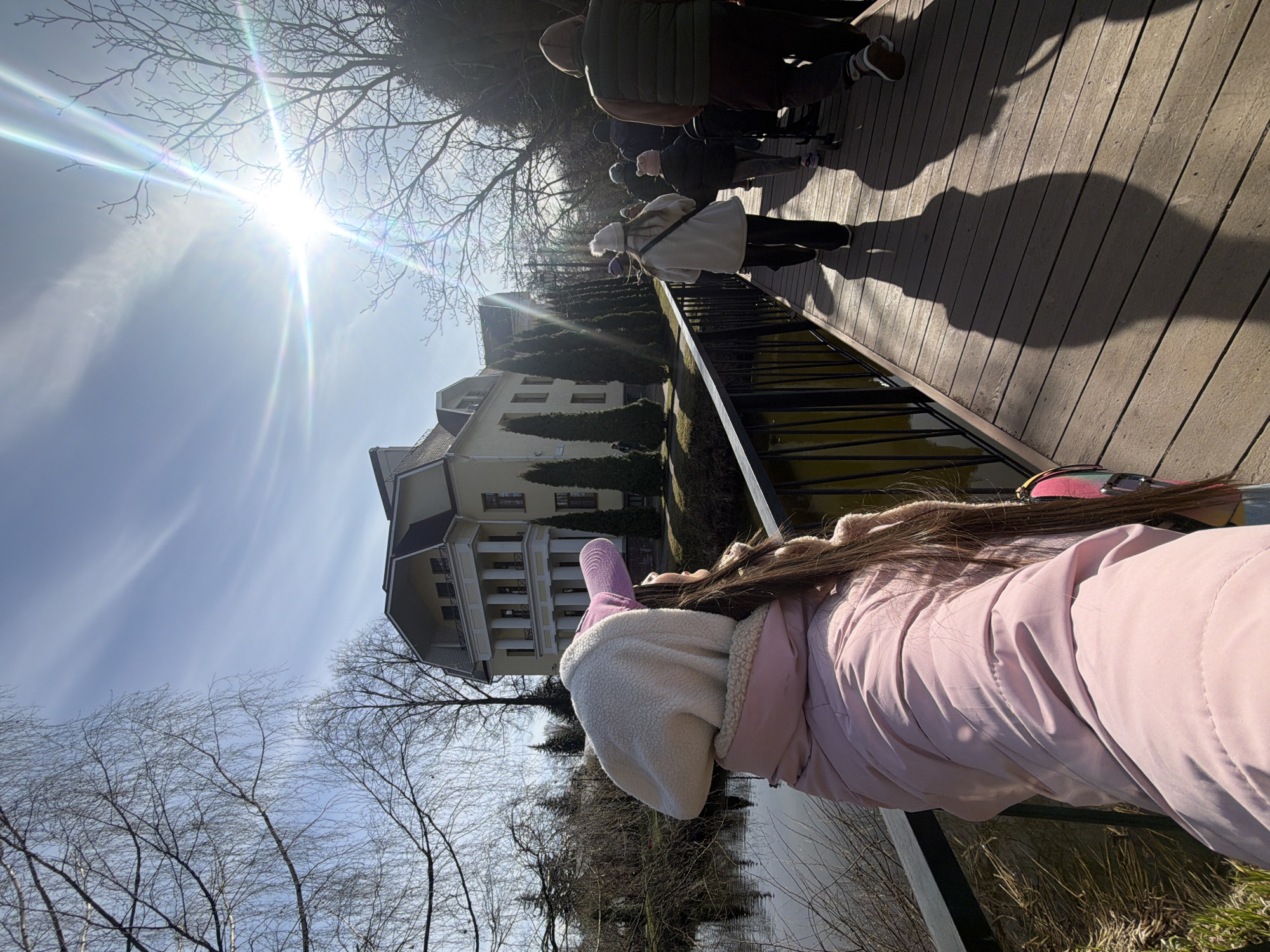 Woman in pink explores Saint Petersburg park on sunny afternoon