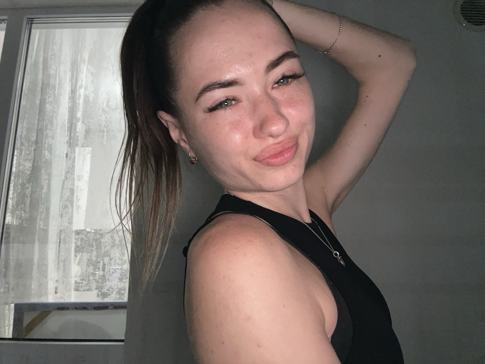 Indoor selfie session, black tank top, varying poses and expressions