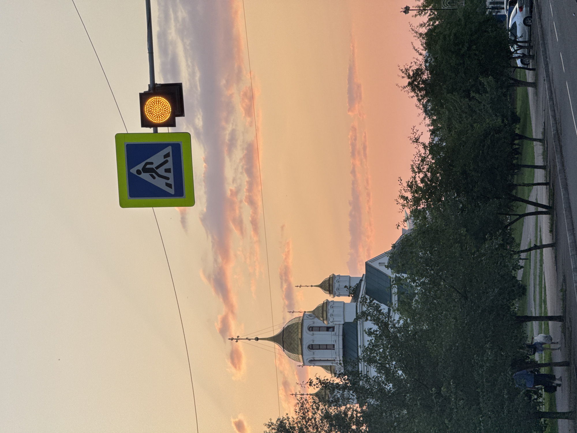 Sunset light over Krasnoyarsk churches, streets, and summer trees