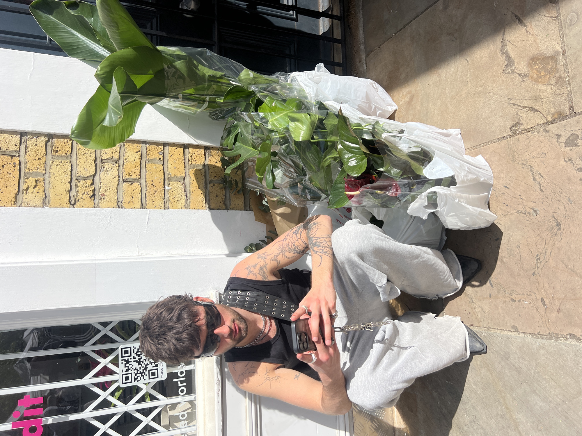 Man sits outside closed London shop