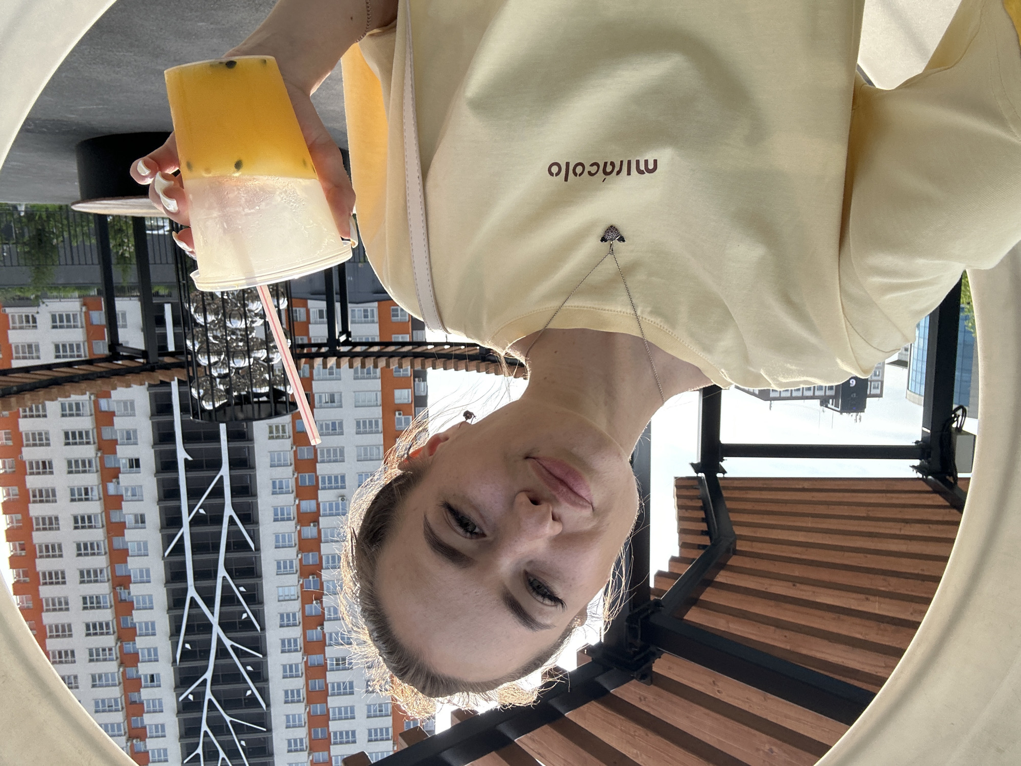 Woman in yellow shirt documents morning selfie tour across city