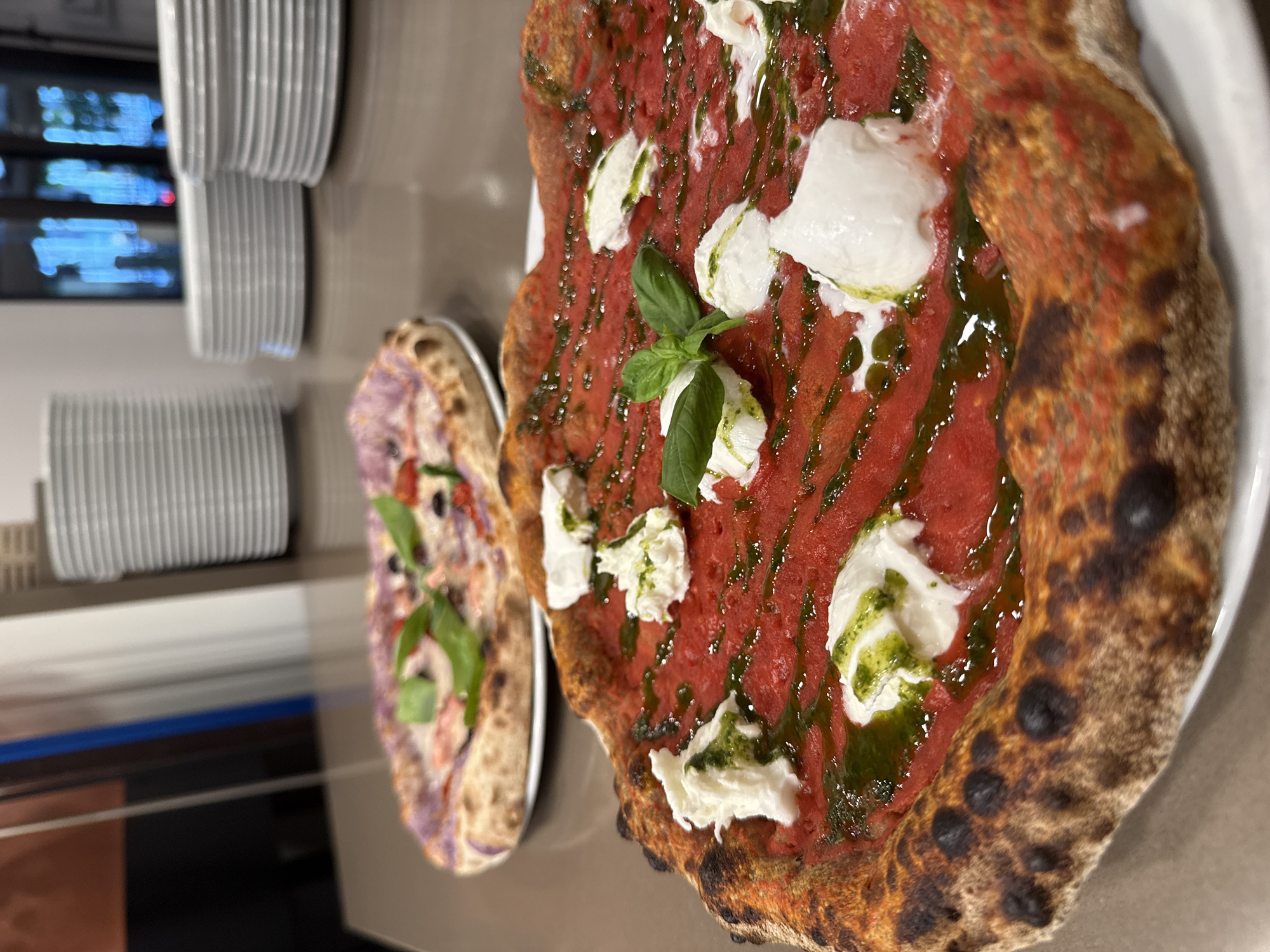 Pizza and plates at a Trento restaurant, late July afternoon