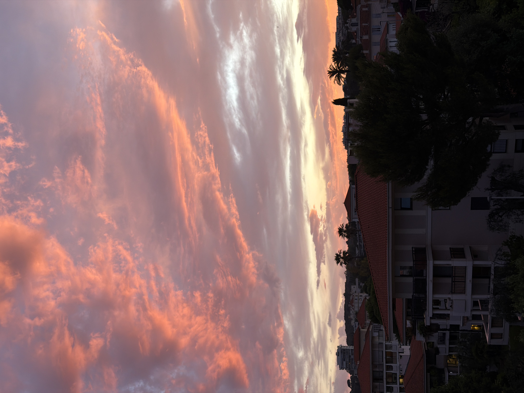 Dramatic sunset illuminates Cannes skyline with vibrant colors