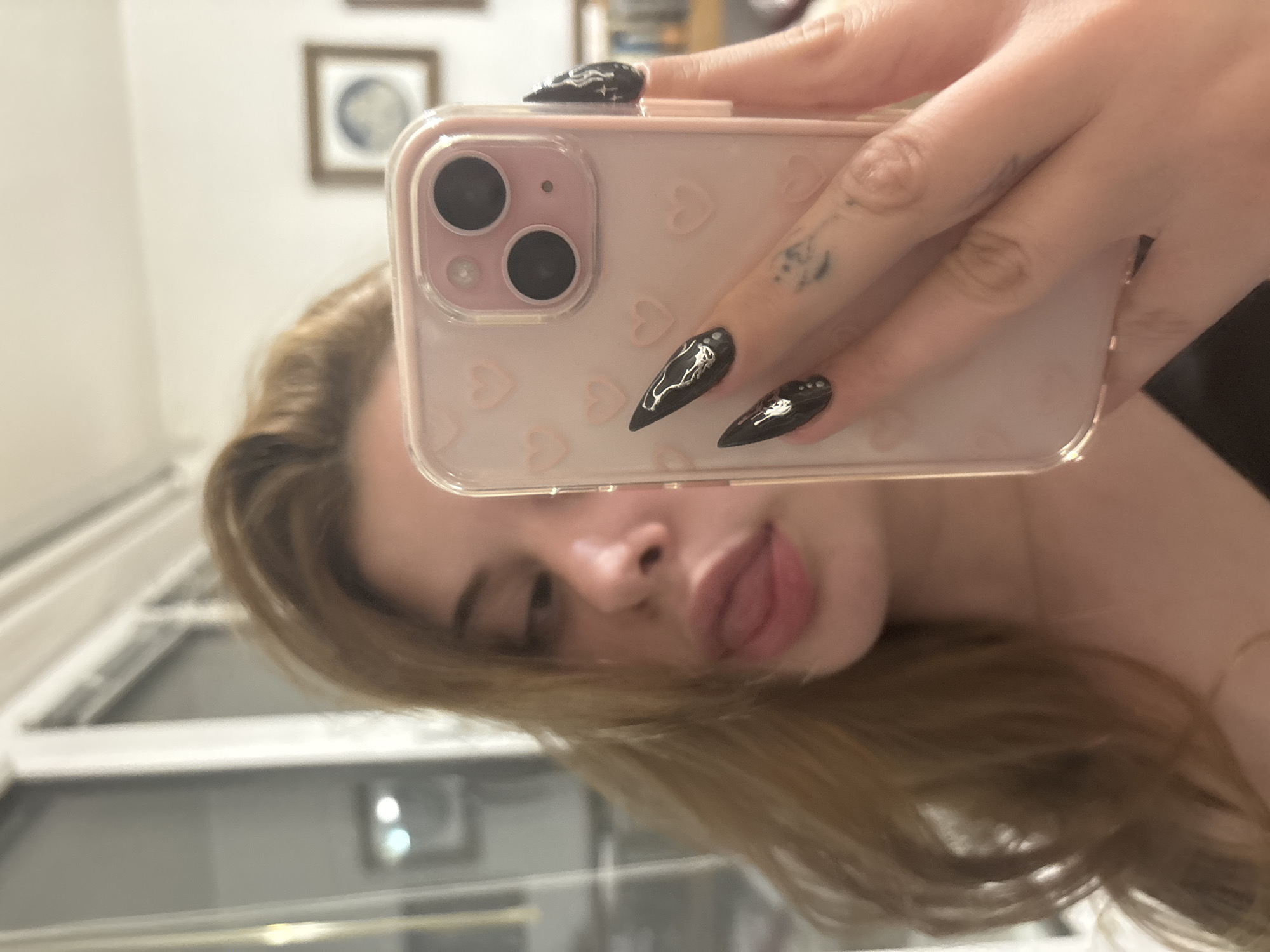 Woman takes bathroom mirror selfies in Troyan, Bulgaria