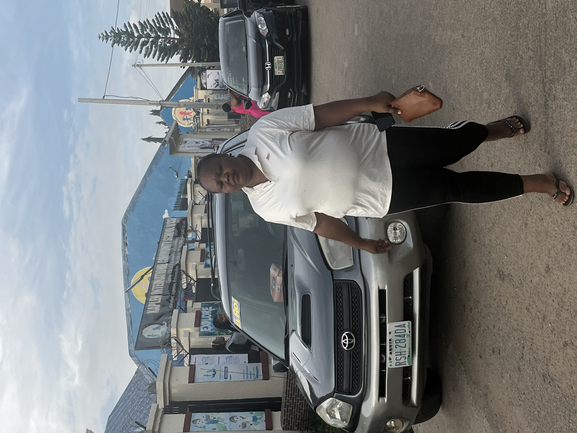 Morning foot traffic on a well-worn Abuja street