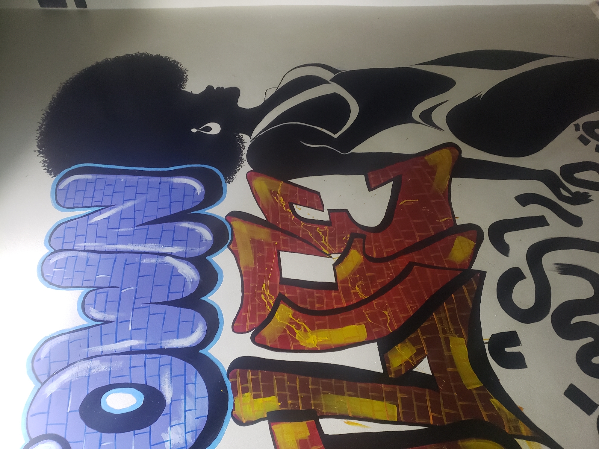 Nighttime scenes captured in Adankolo include street art and dining