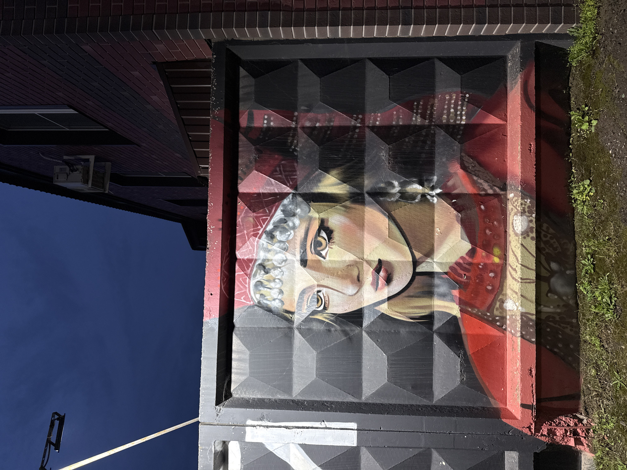 Street murals and public art line the walls of Sharkan, Russia