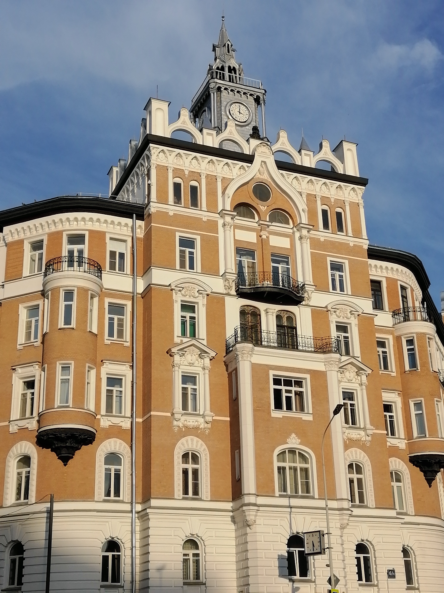 Moscow street corner: brick architecture, bronze statue, tram tracks