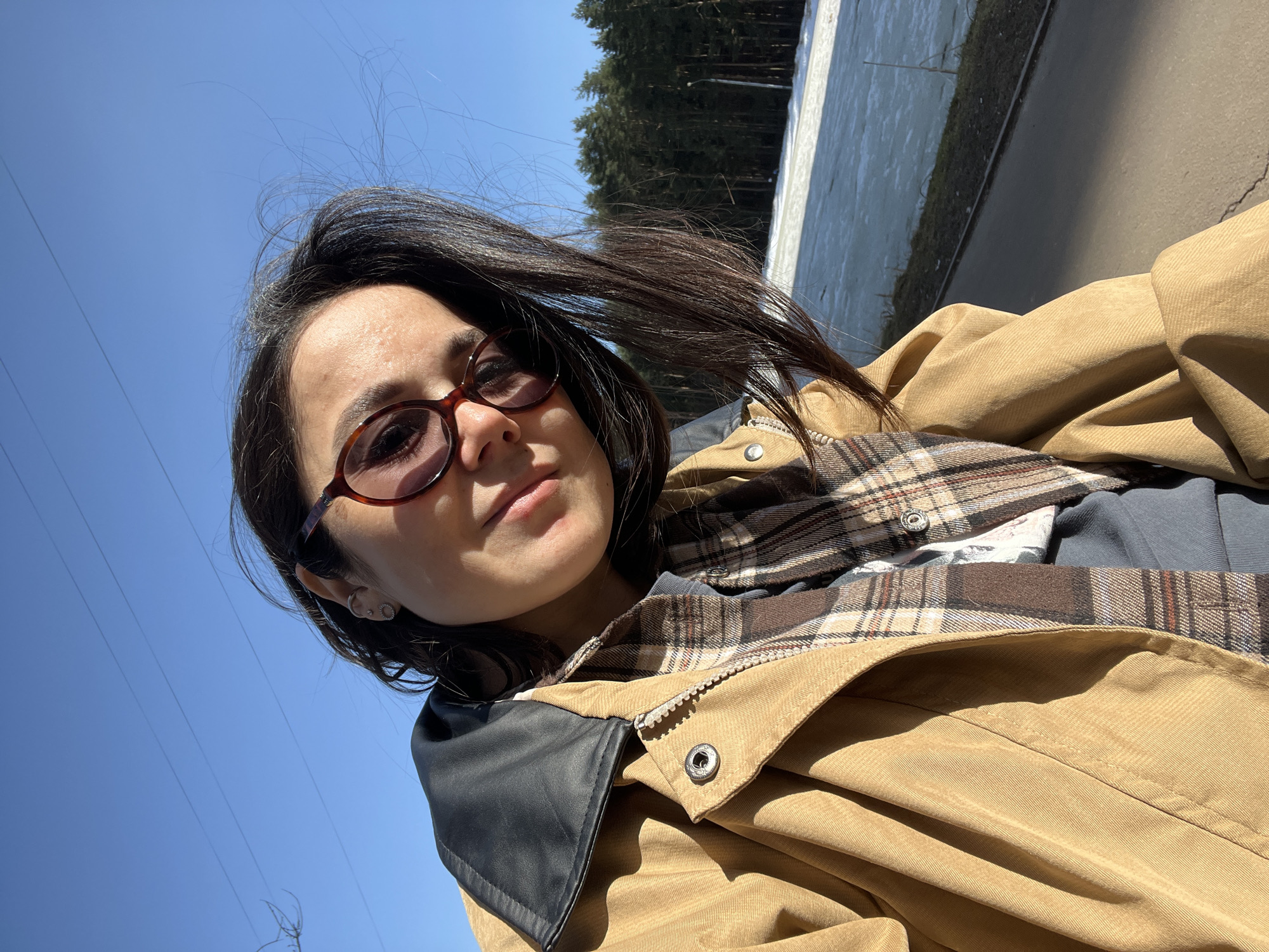 Woman takes selfies at frozen waterfront in Podolsk