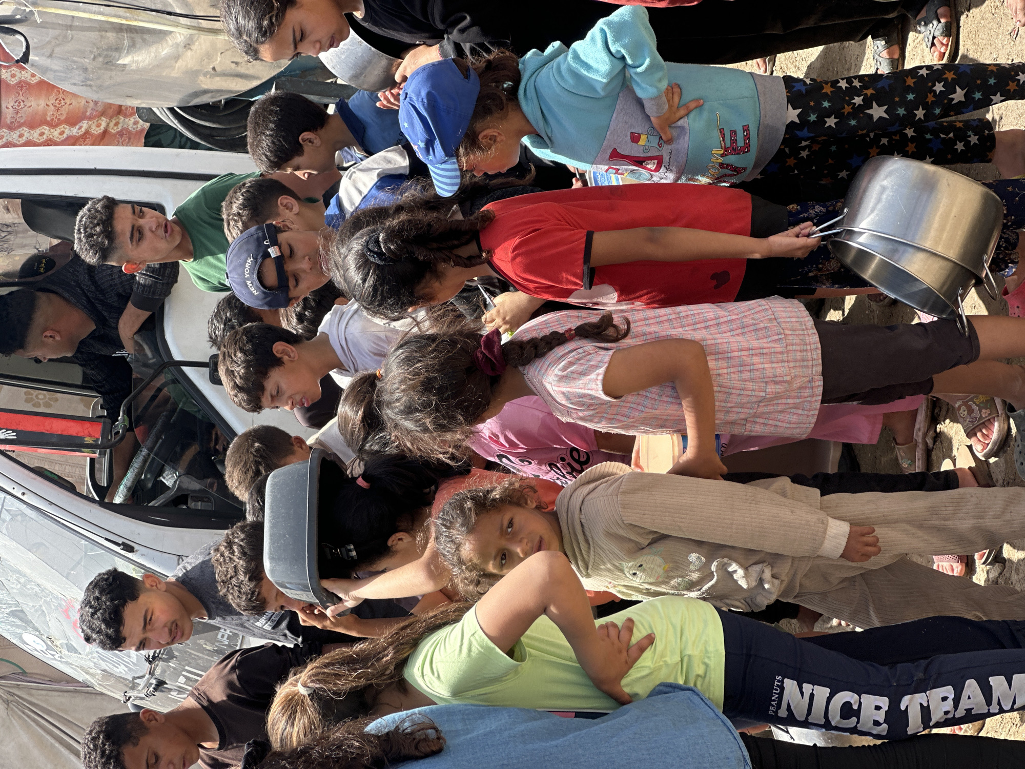 Gaza residents collect aid amid damaged buildings, temporary shelters