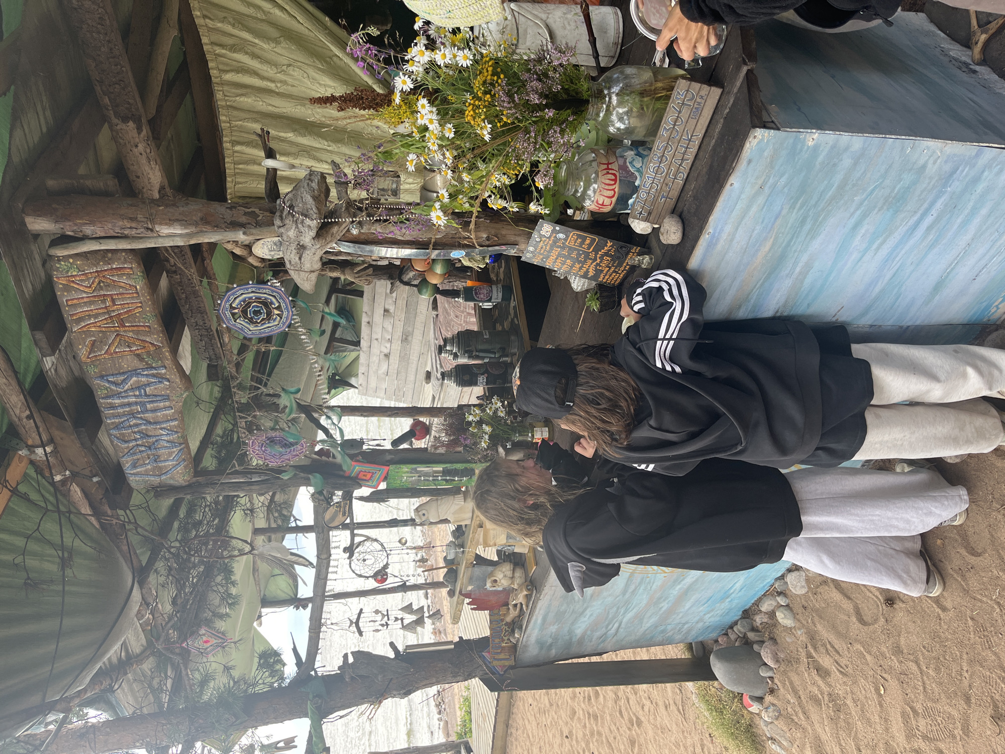 Instruments and art set up at a casual beachside gathering spot