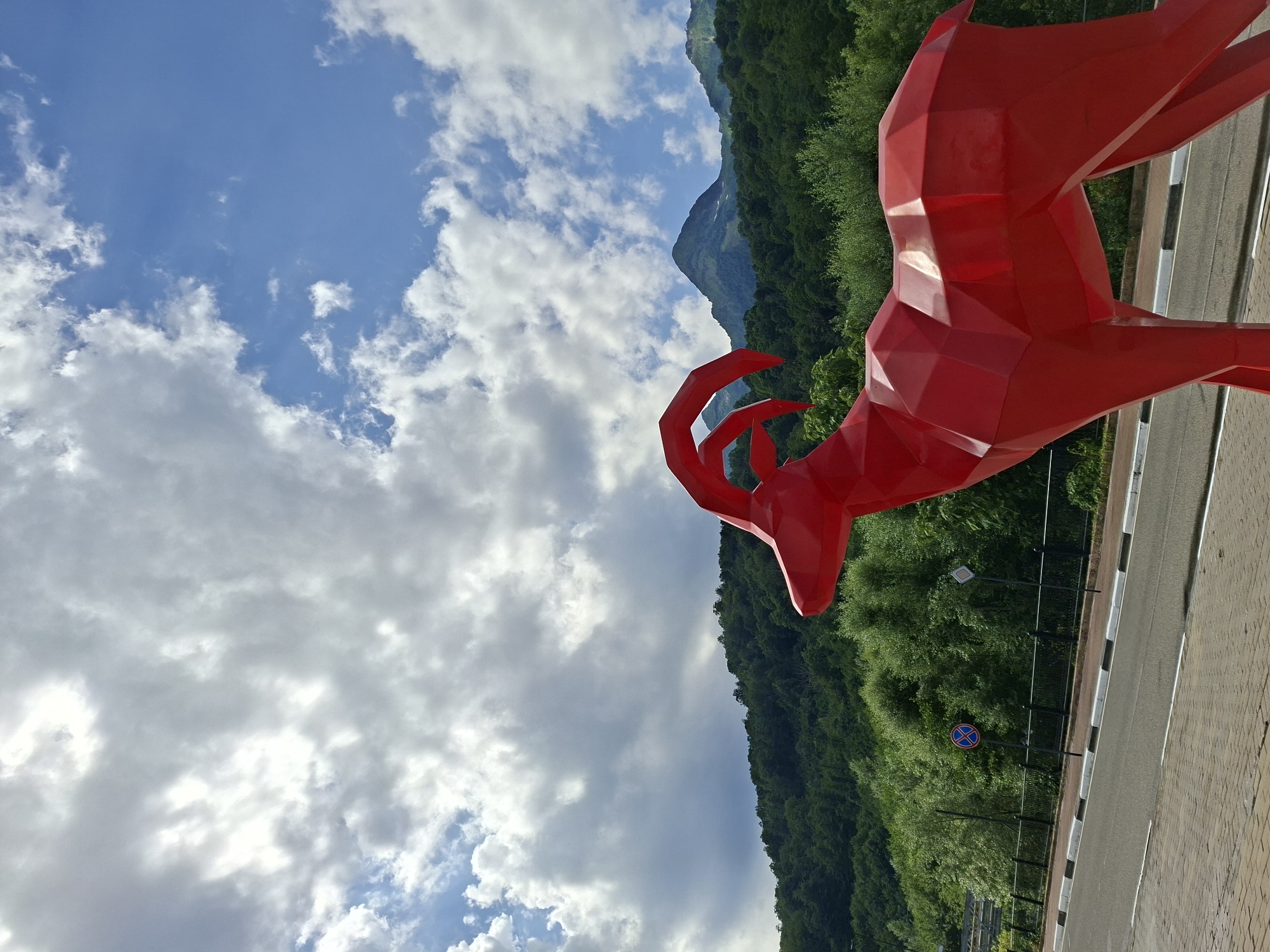 Red geometric goat sculpture near cable car station, Estosadok