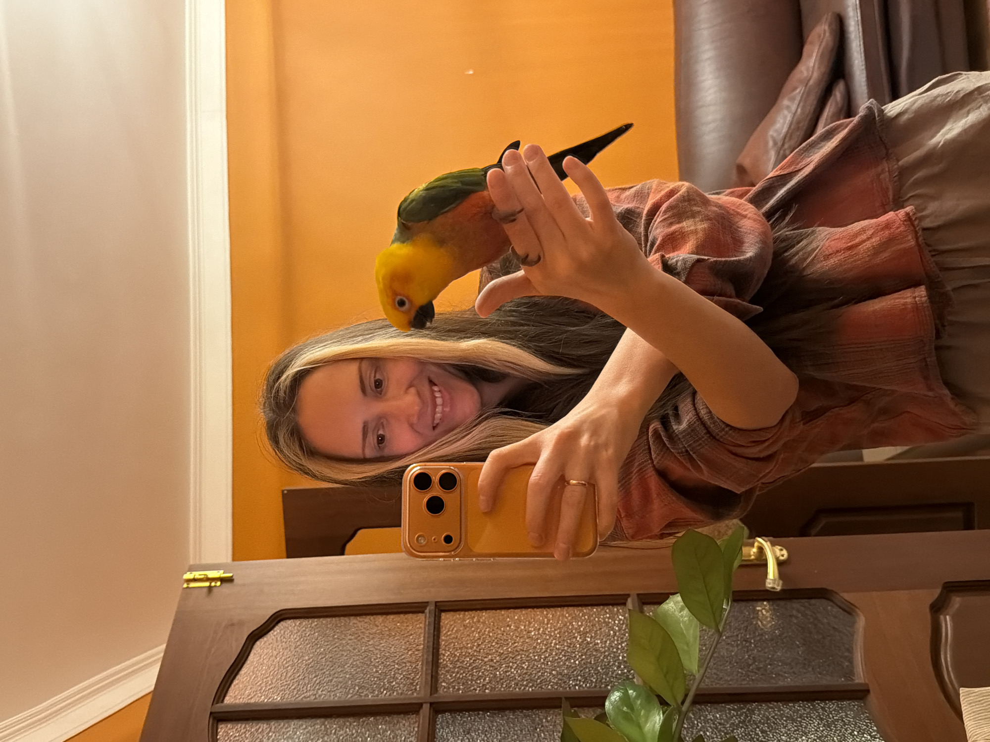 Woman poses with sun conure parrot in Khimki selfie