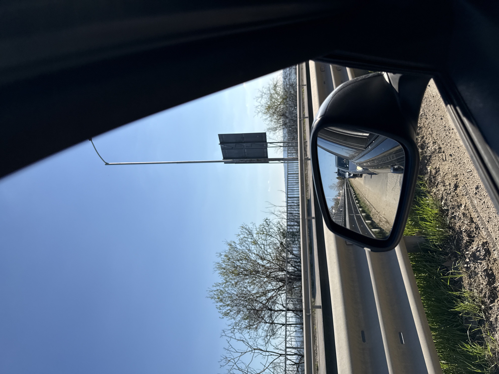 Highway traffic observed via side mirror near Varna