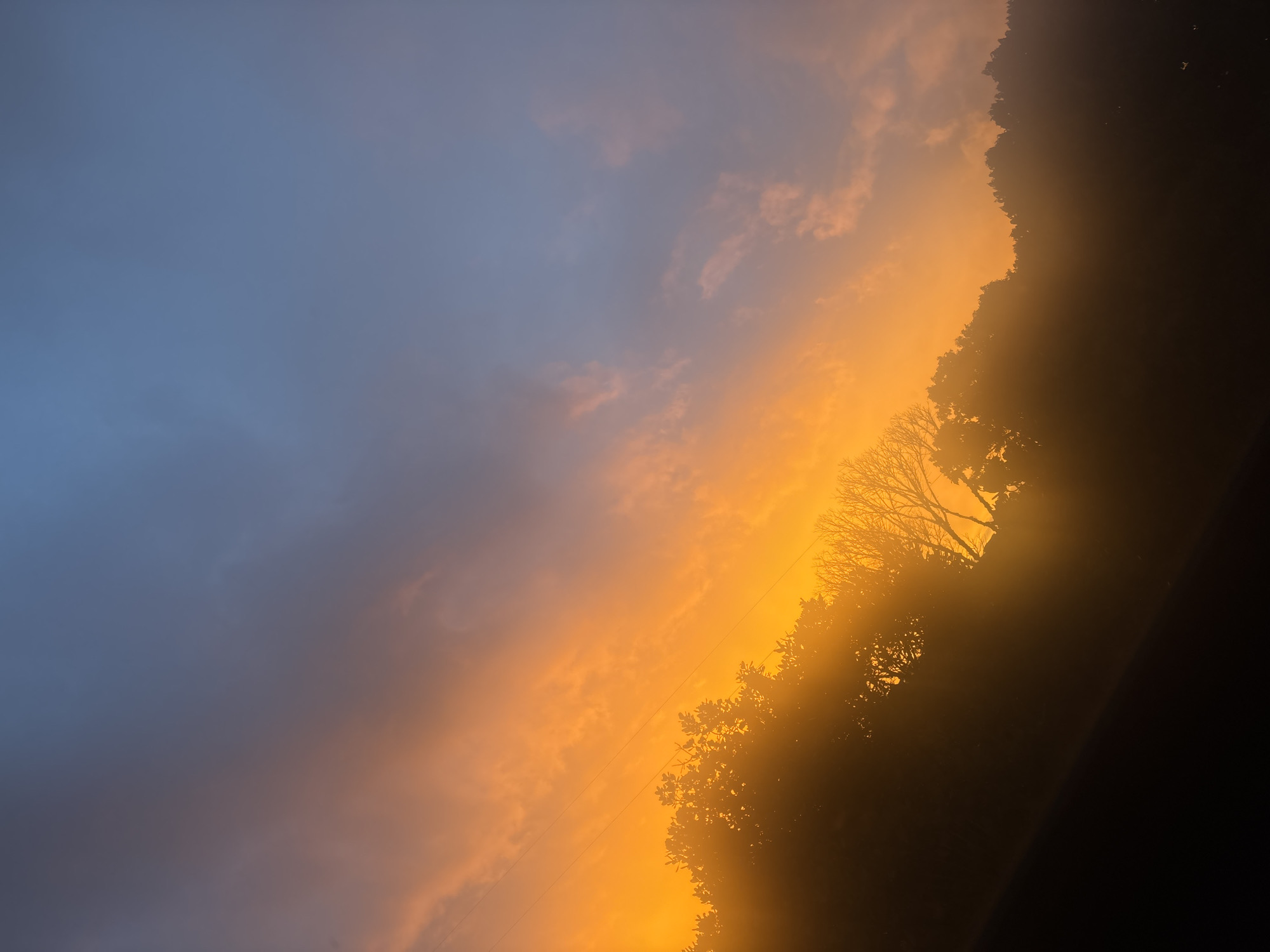 Sunset observed over Guarne, Colombia creates orange-blue sky display