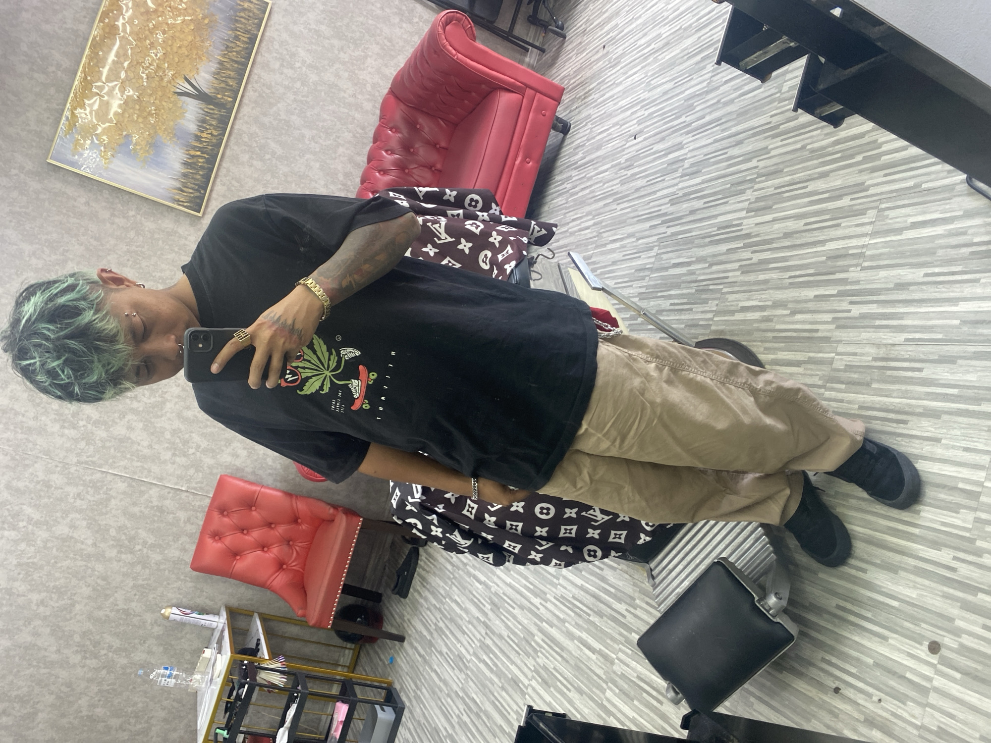 Person takes selfie in art-decorated indoor space, Kuta