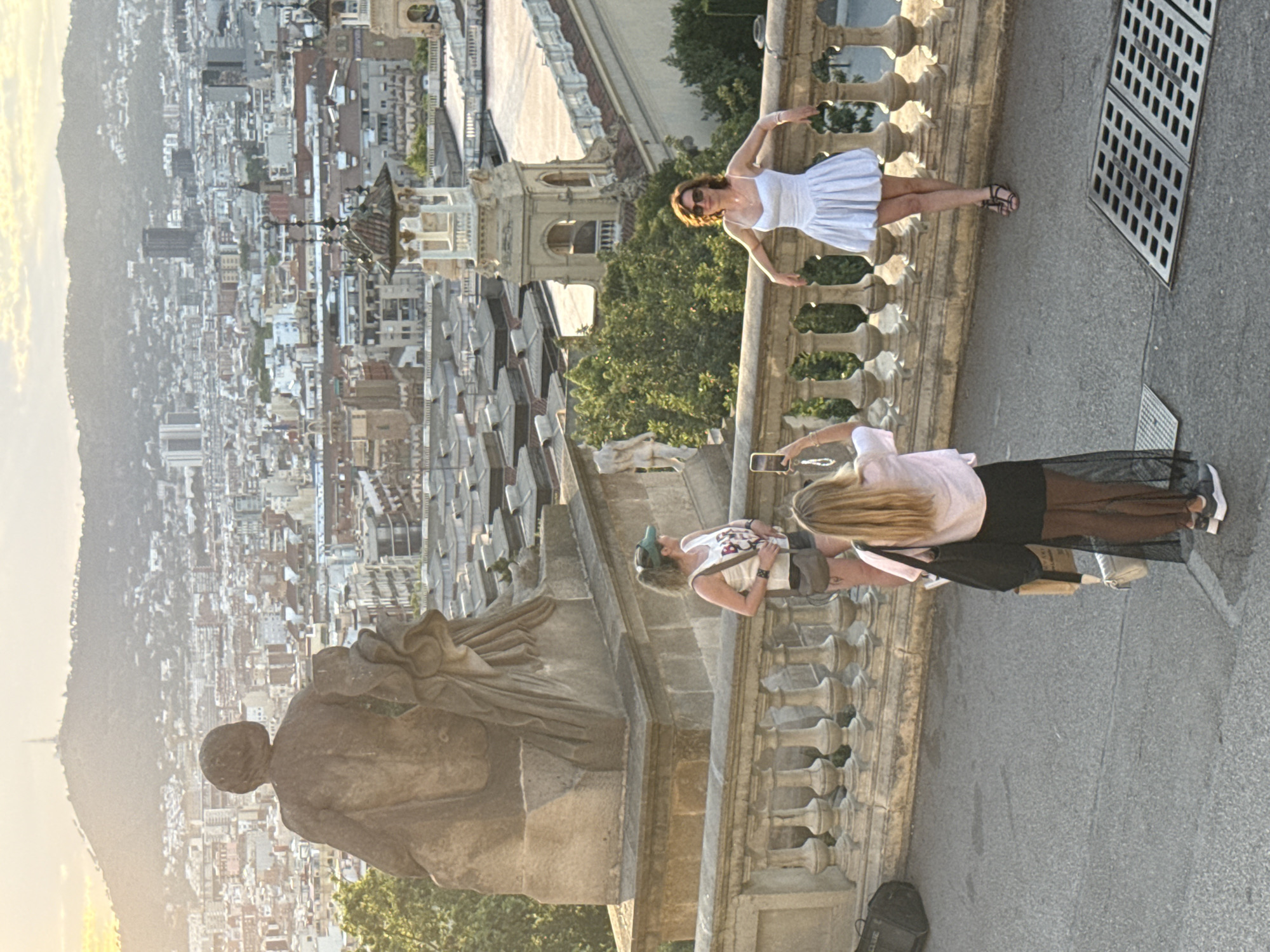 Tourists enjoy Barcelona landmarks during sunny afternoon sightseeing session