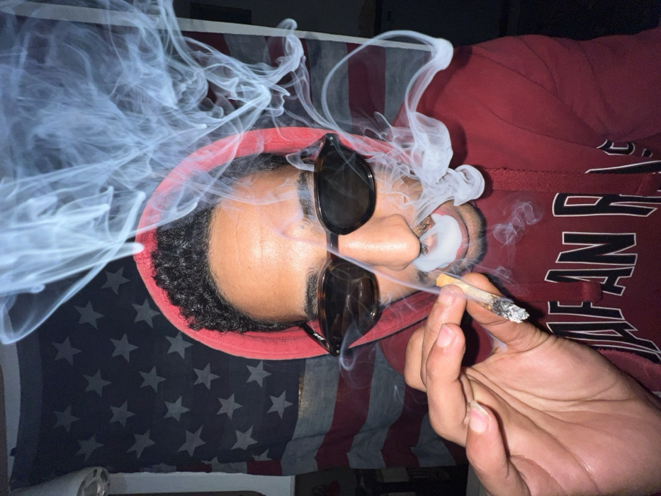 Man smoking, writing on fogged window in Tangier residence
