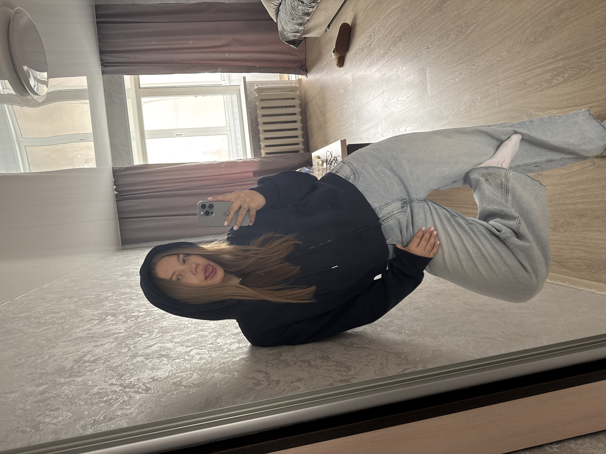 Woman takes morning selfies with cat in Russian bedroom