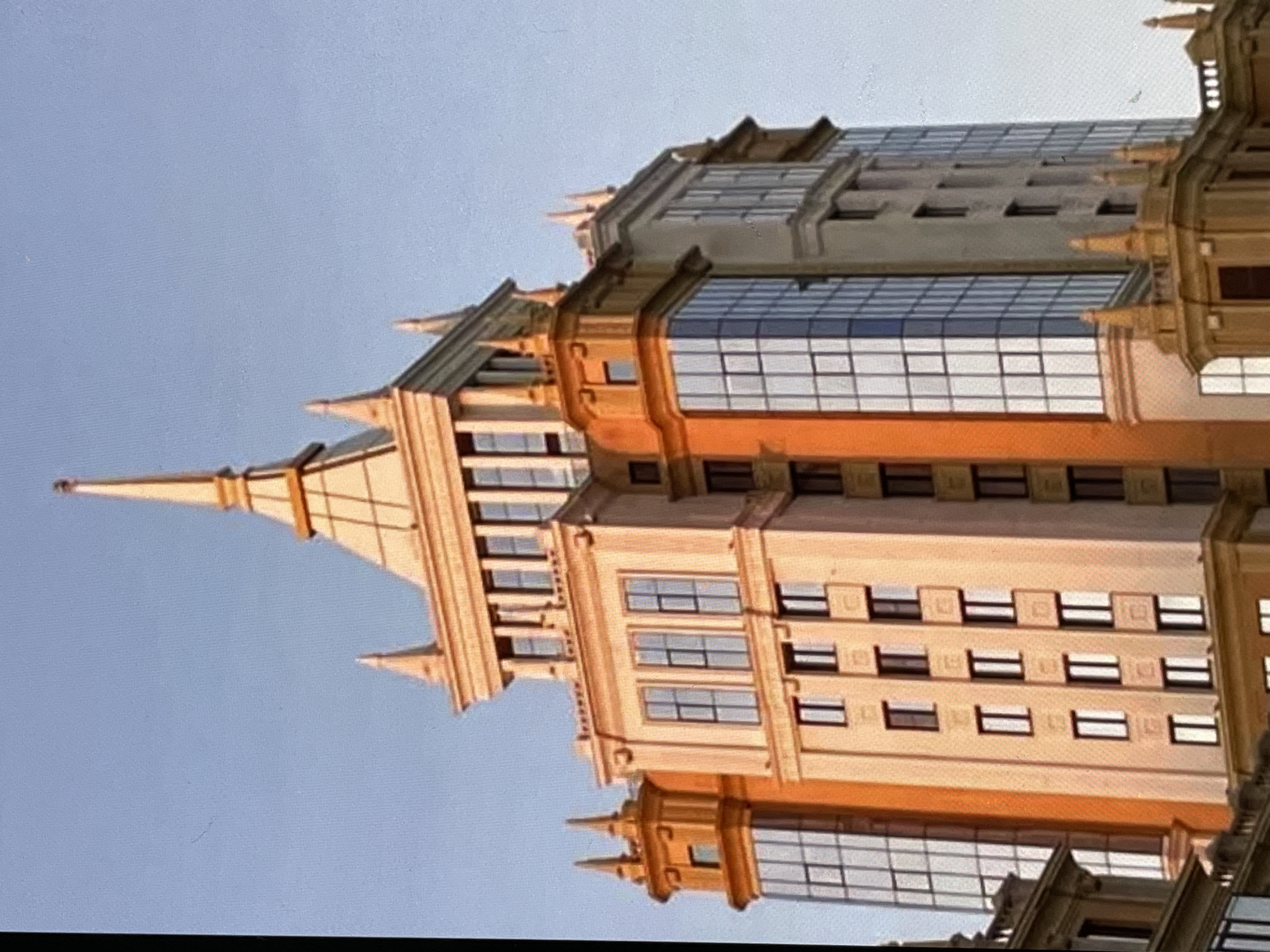 Stalinist spire anchors a Russian city skyline at dusk