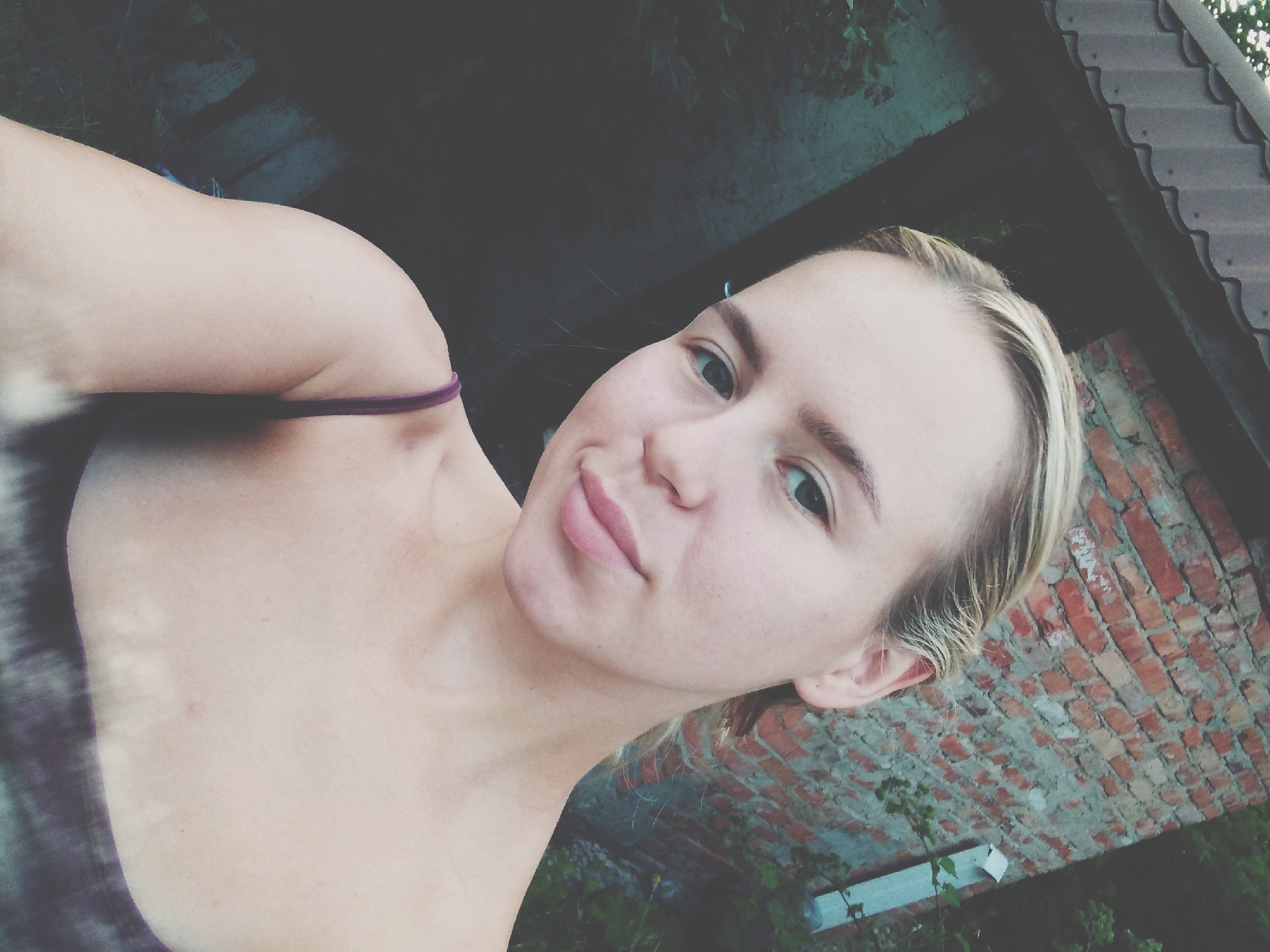 Outdoor selfie against brick wall in Radisne, Ukraine