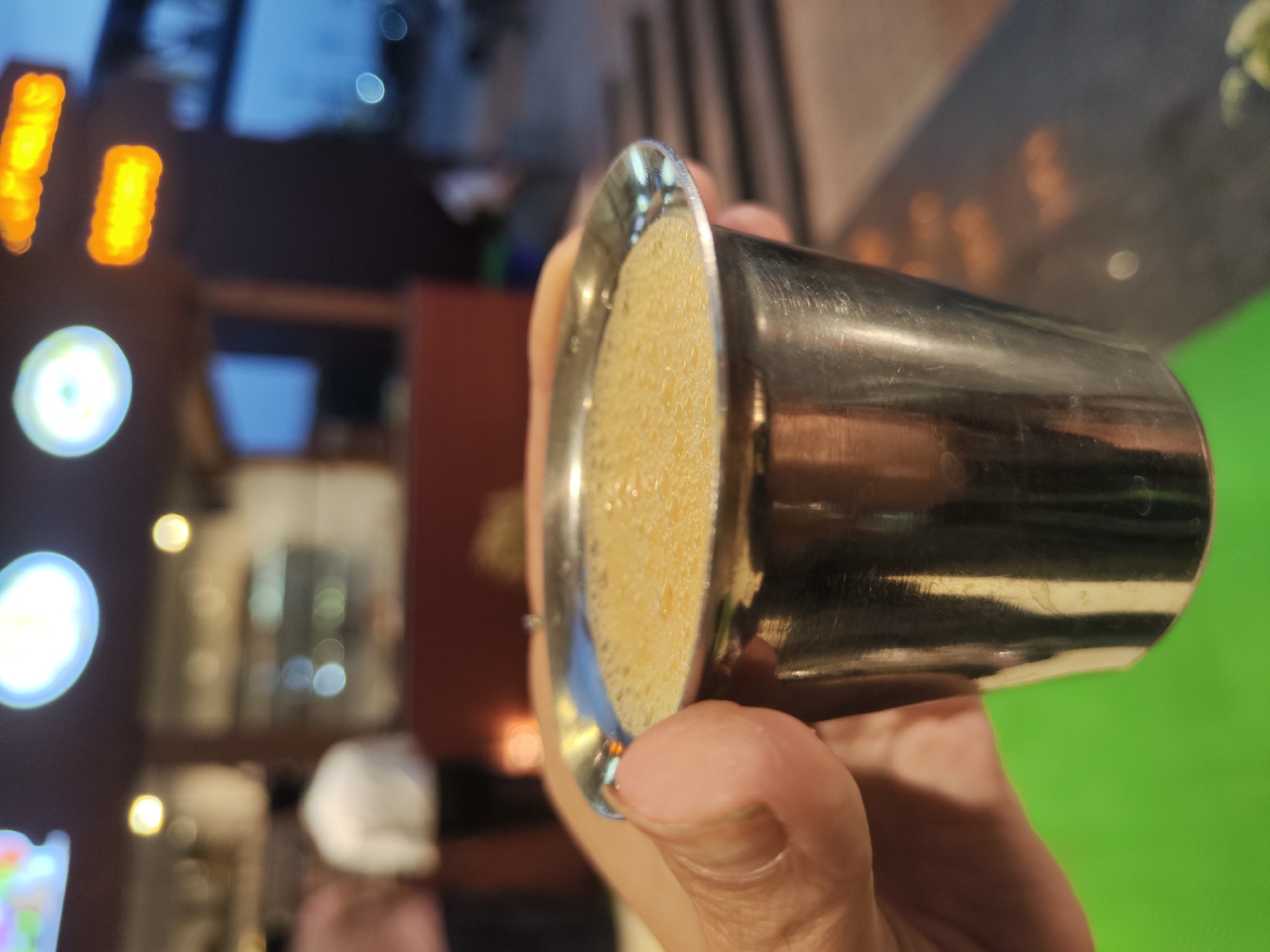 Beverage service documented at Mudugurki establishment with decorative lighting