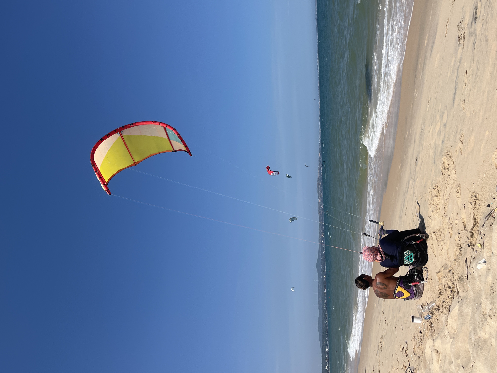 Kitesurfing and beach life along Mũi Né's coastline at dawn