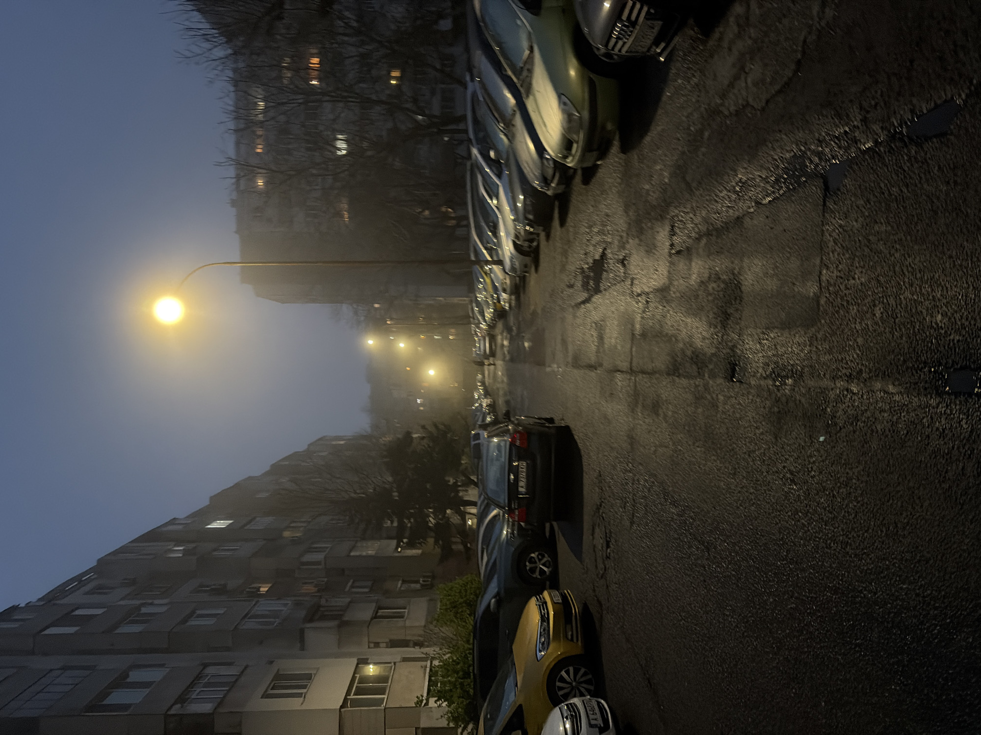 Foggy evening street scene and amusement park documented in Burgas