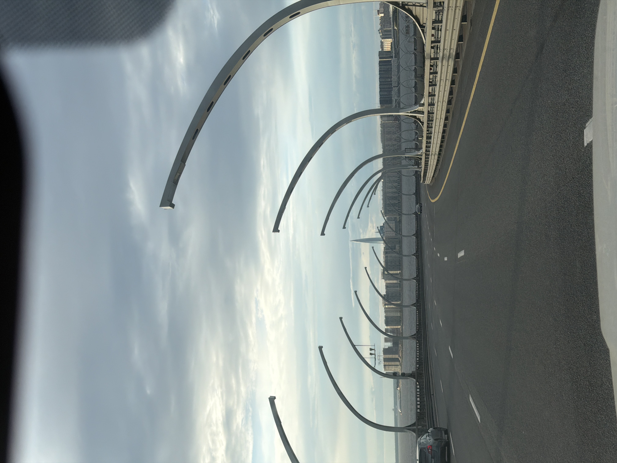 Urban highway drive crossing cable-stayed bridges past a city skyline