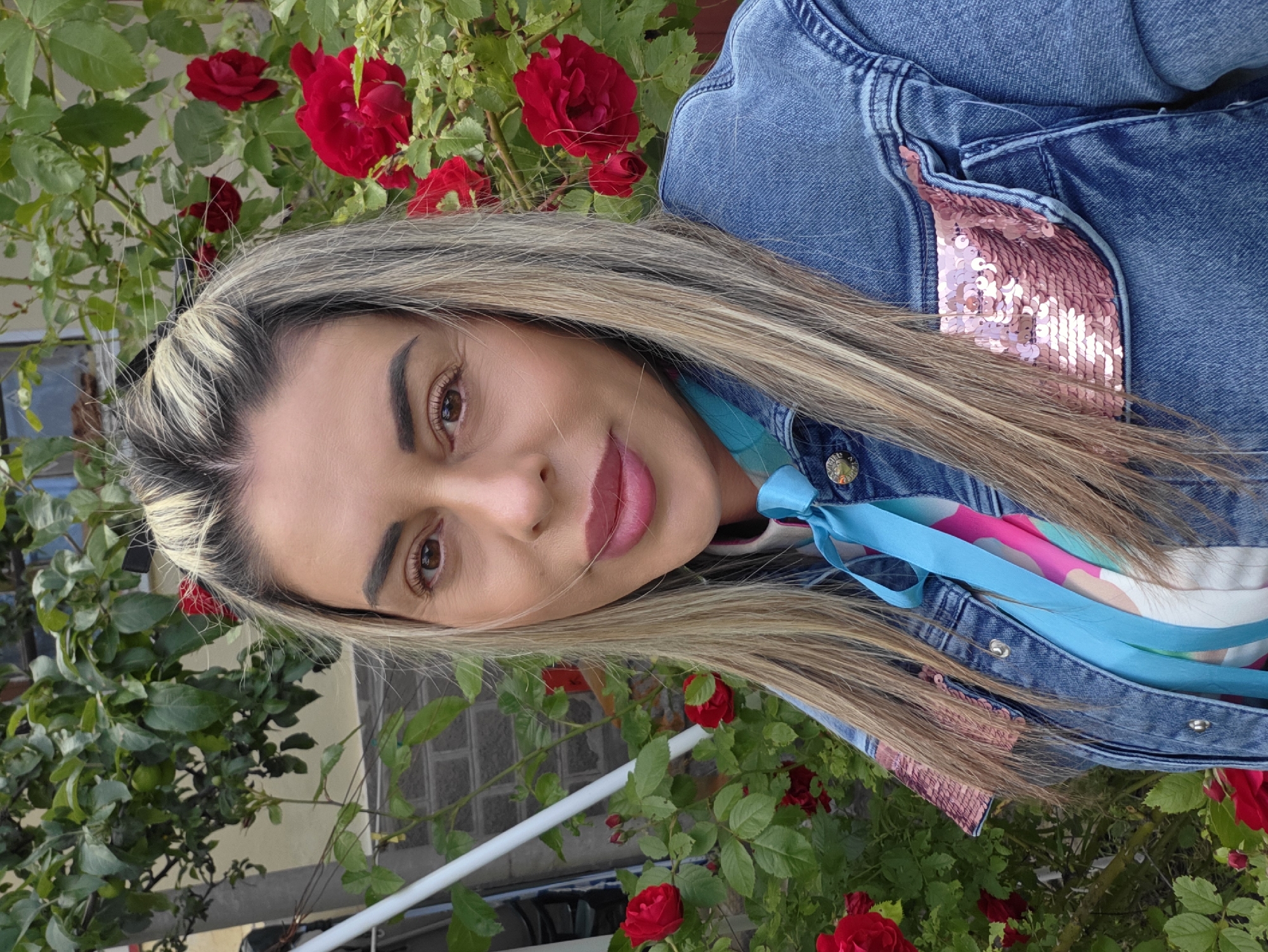 Portrait in front of red roses, Ravnogor, Bulgaria