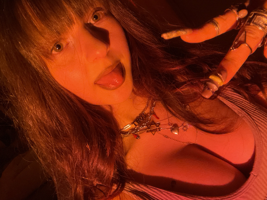 Woman conducts late-night photo session in dramatic lighting, Raanana