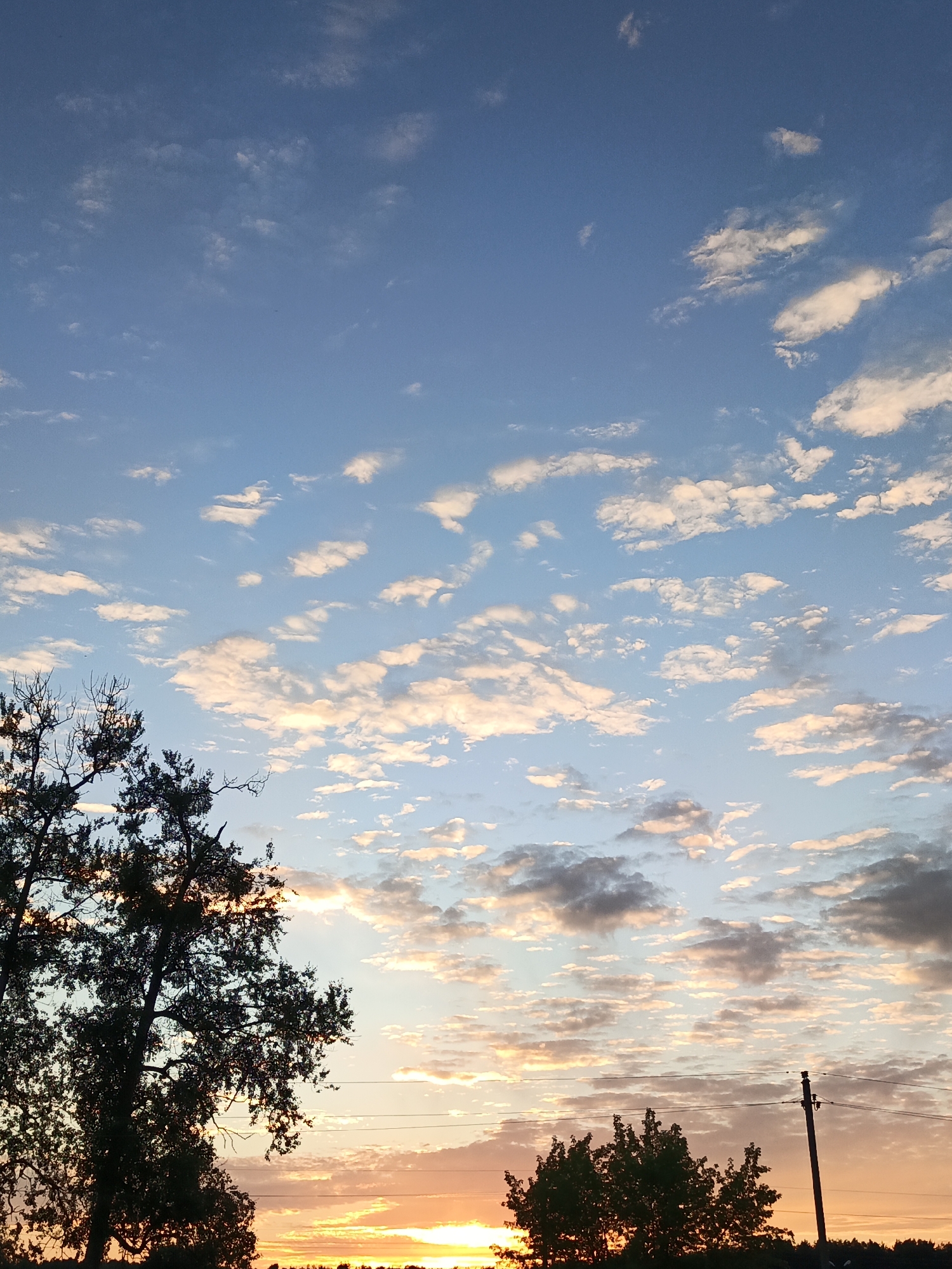 Sunset over rural Belarus, open skies and a railway crossing