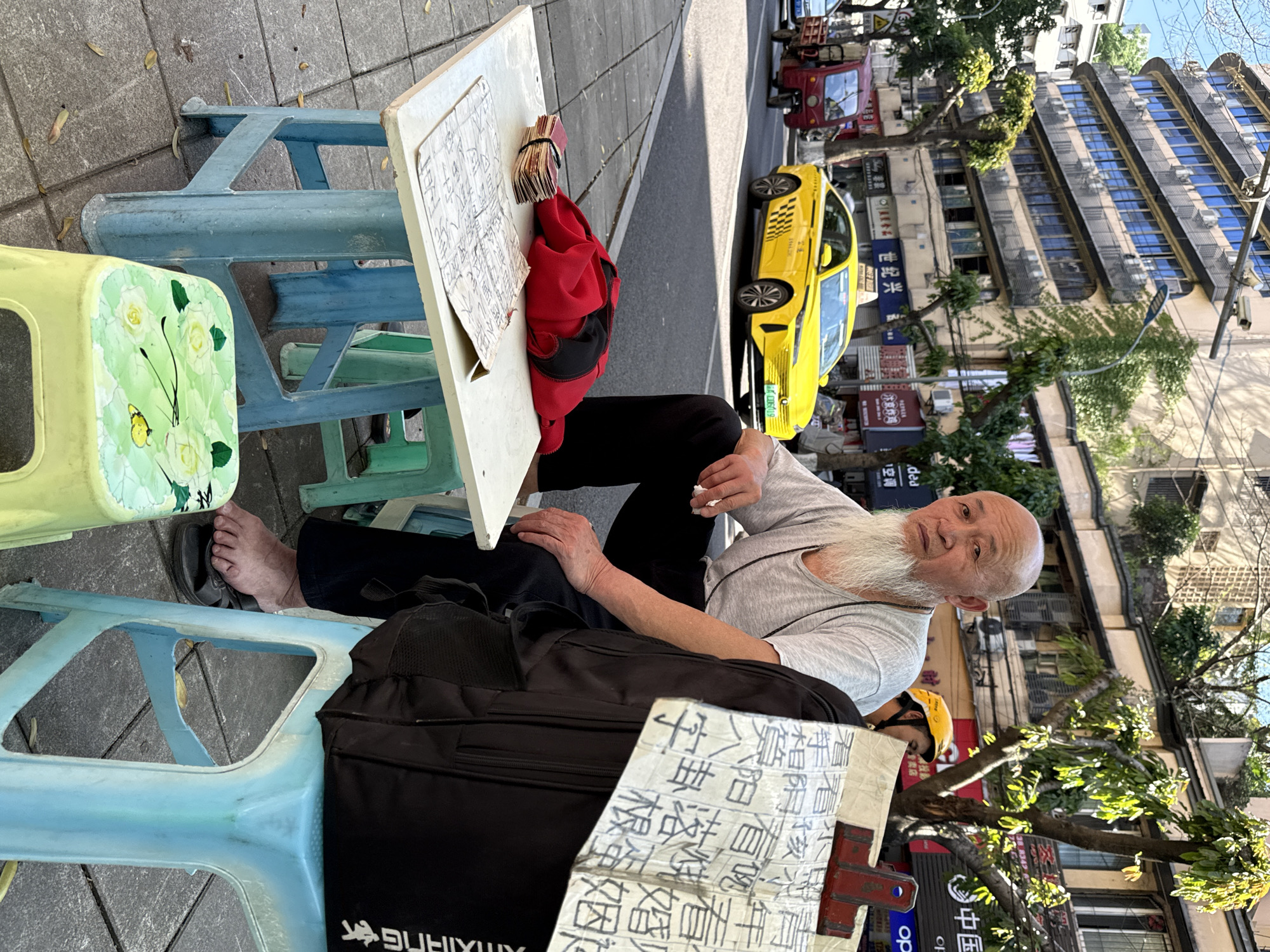 Man conducts sidewalk business in Beibei, China