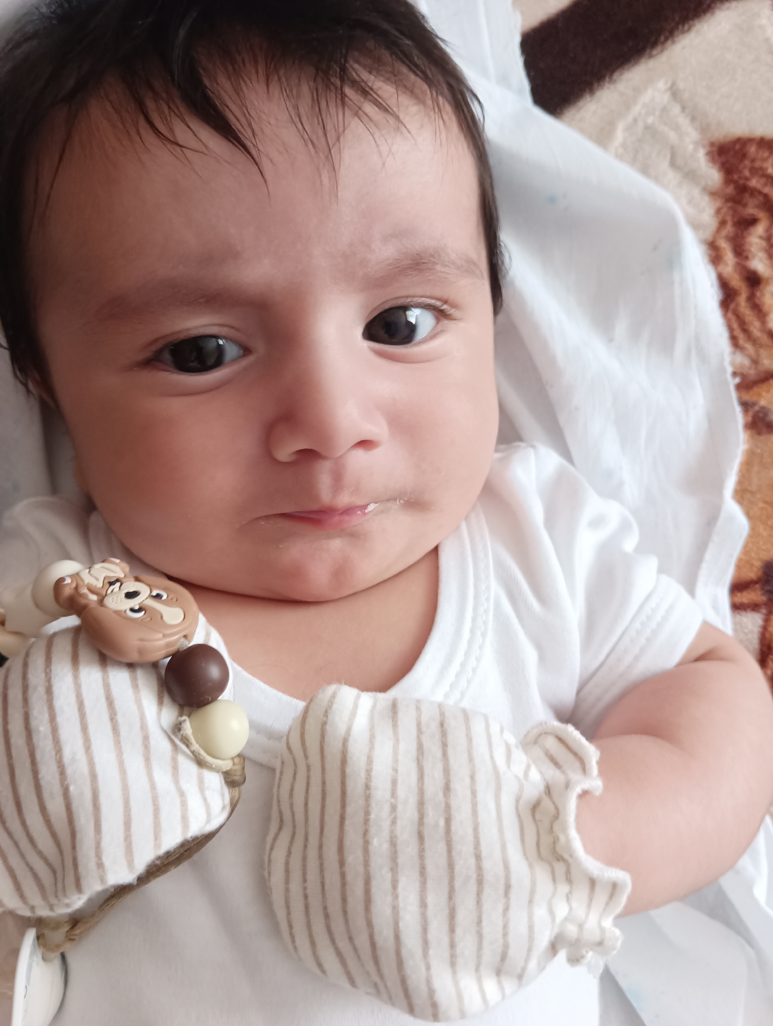 Baby in white onesie photographed in Yerevan