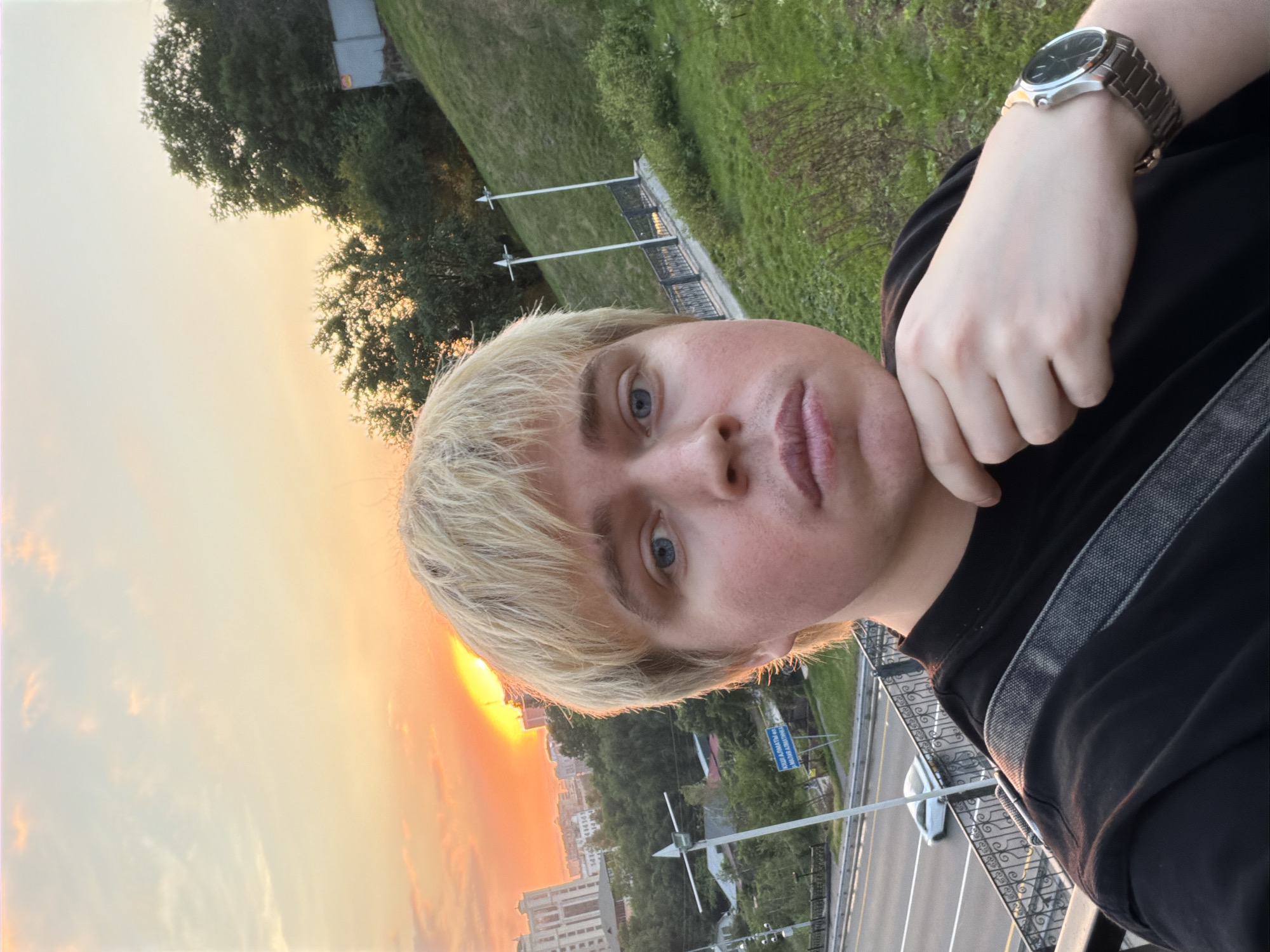 Tourist captures sunset selfie over Almaty cityscape