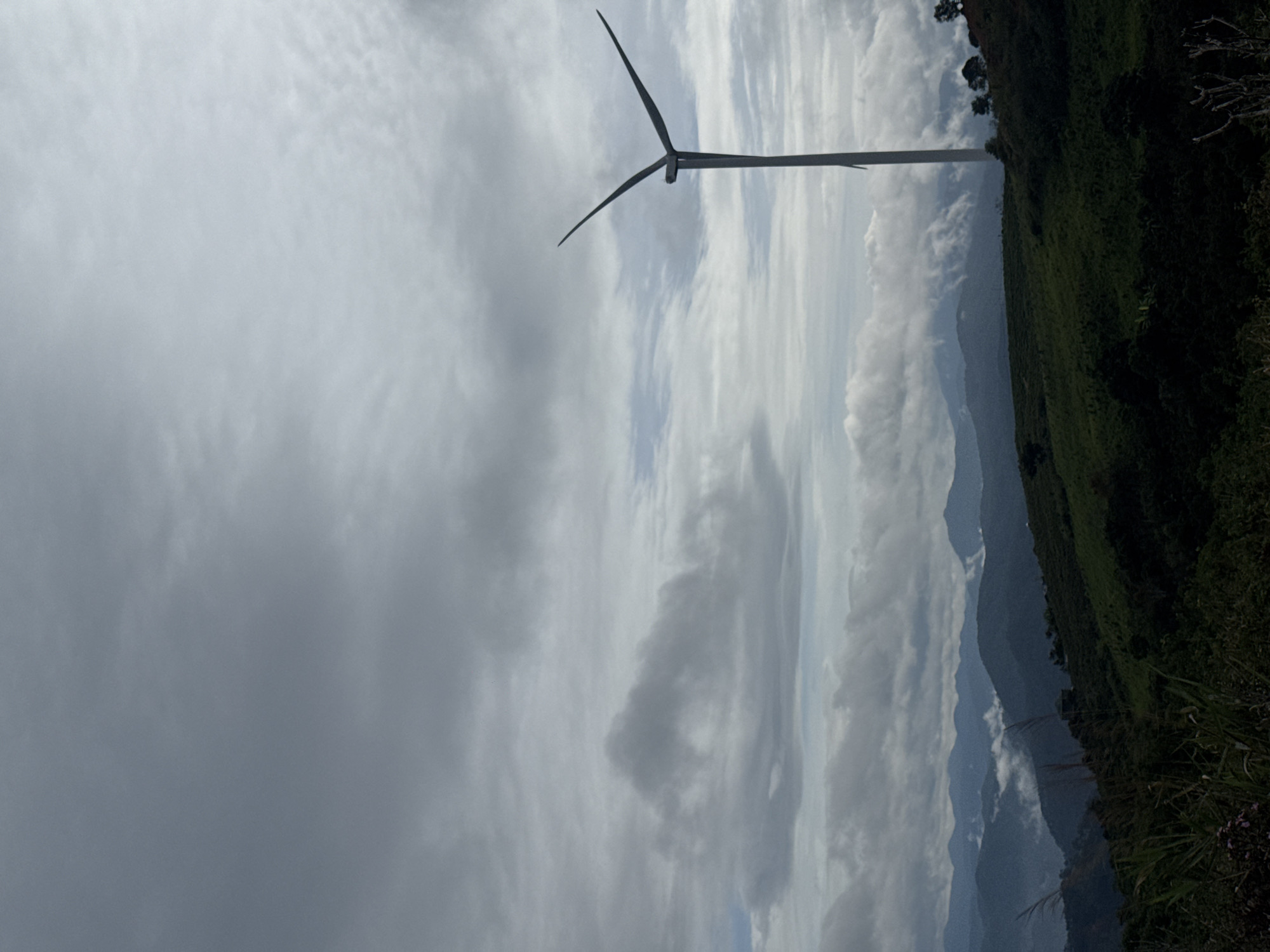 Wind turbines documented across mountainous Vietnam region during cloudy morning