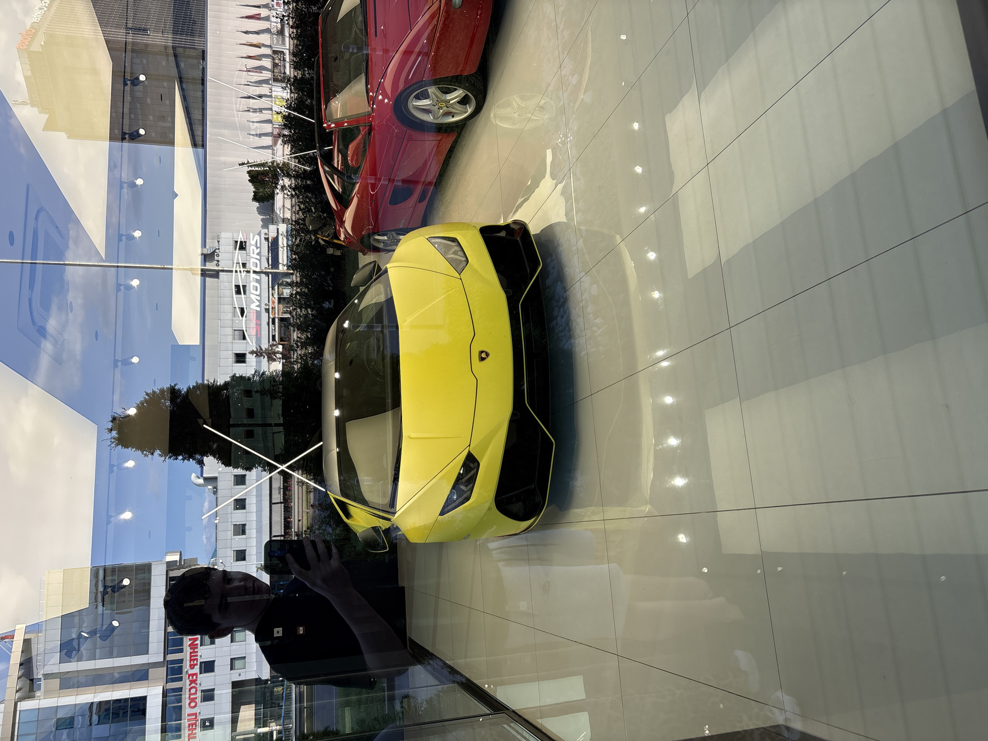 Sofia residents document luxury car, selfie, evening cityscape