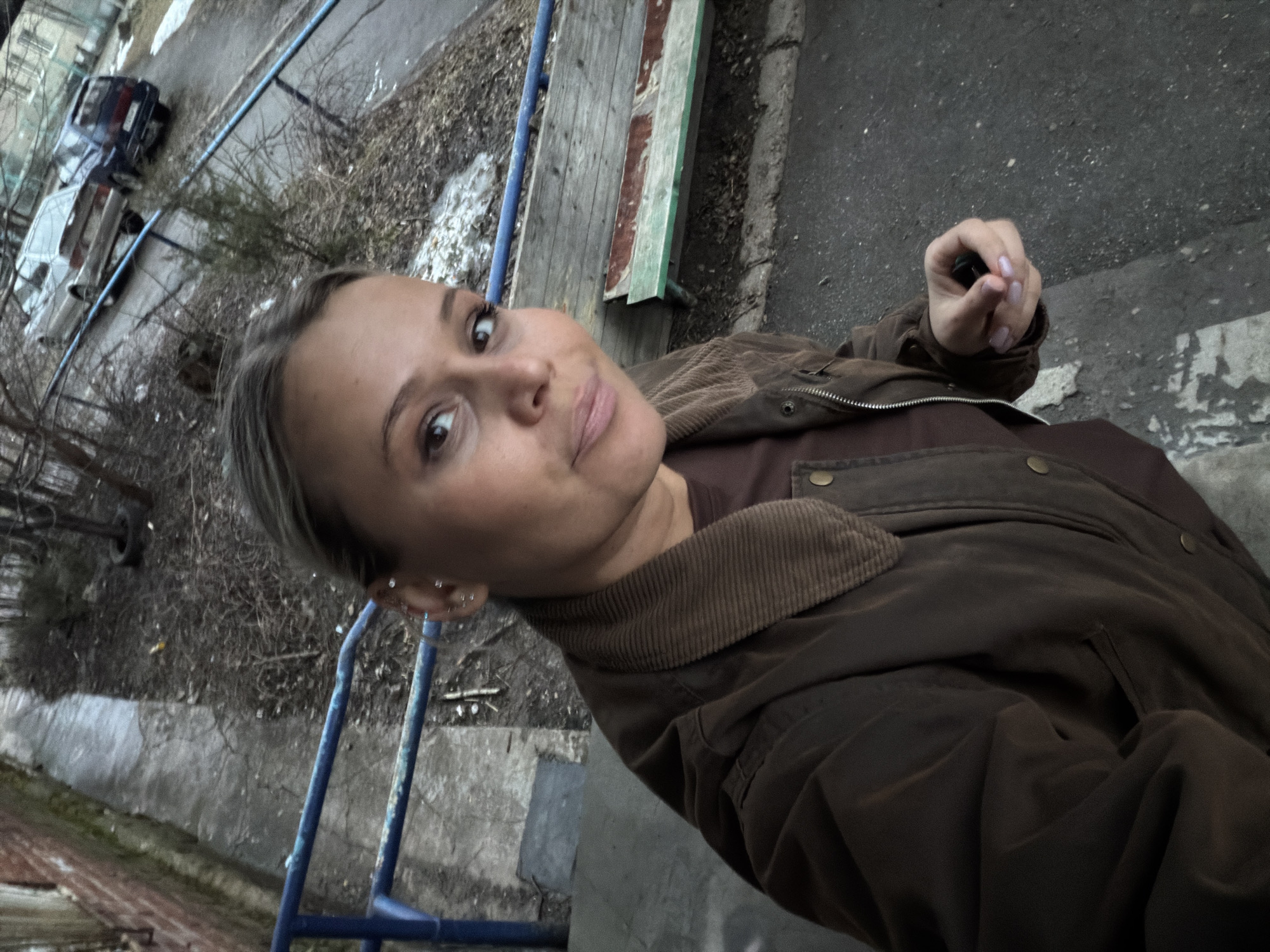 Woman takes selfies around Sarapul, Russia buildings and car
