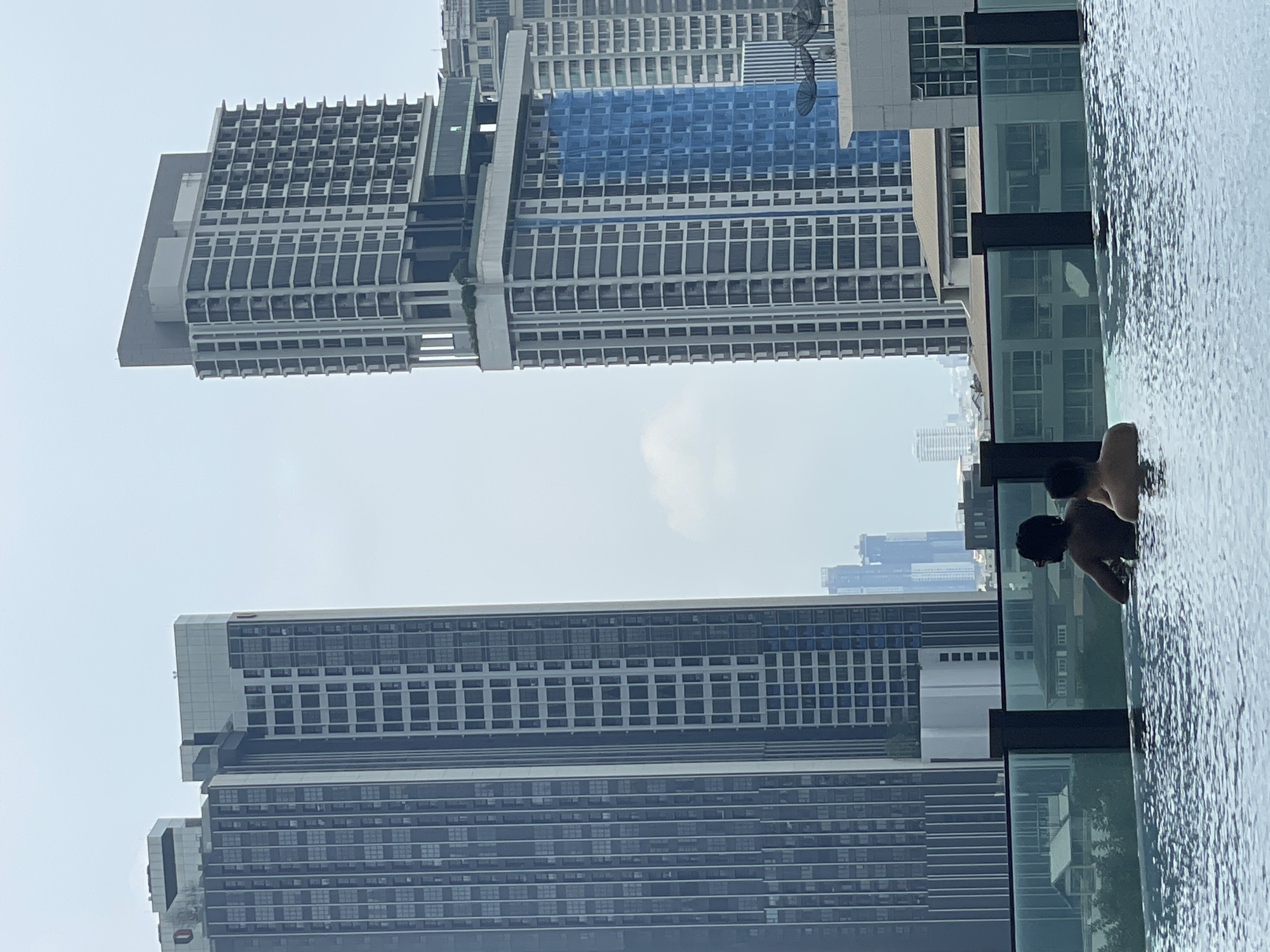 Early morning rooftop pool relaxation captured in Bangkok skyline