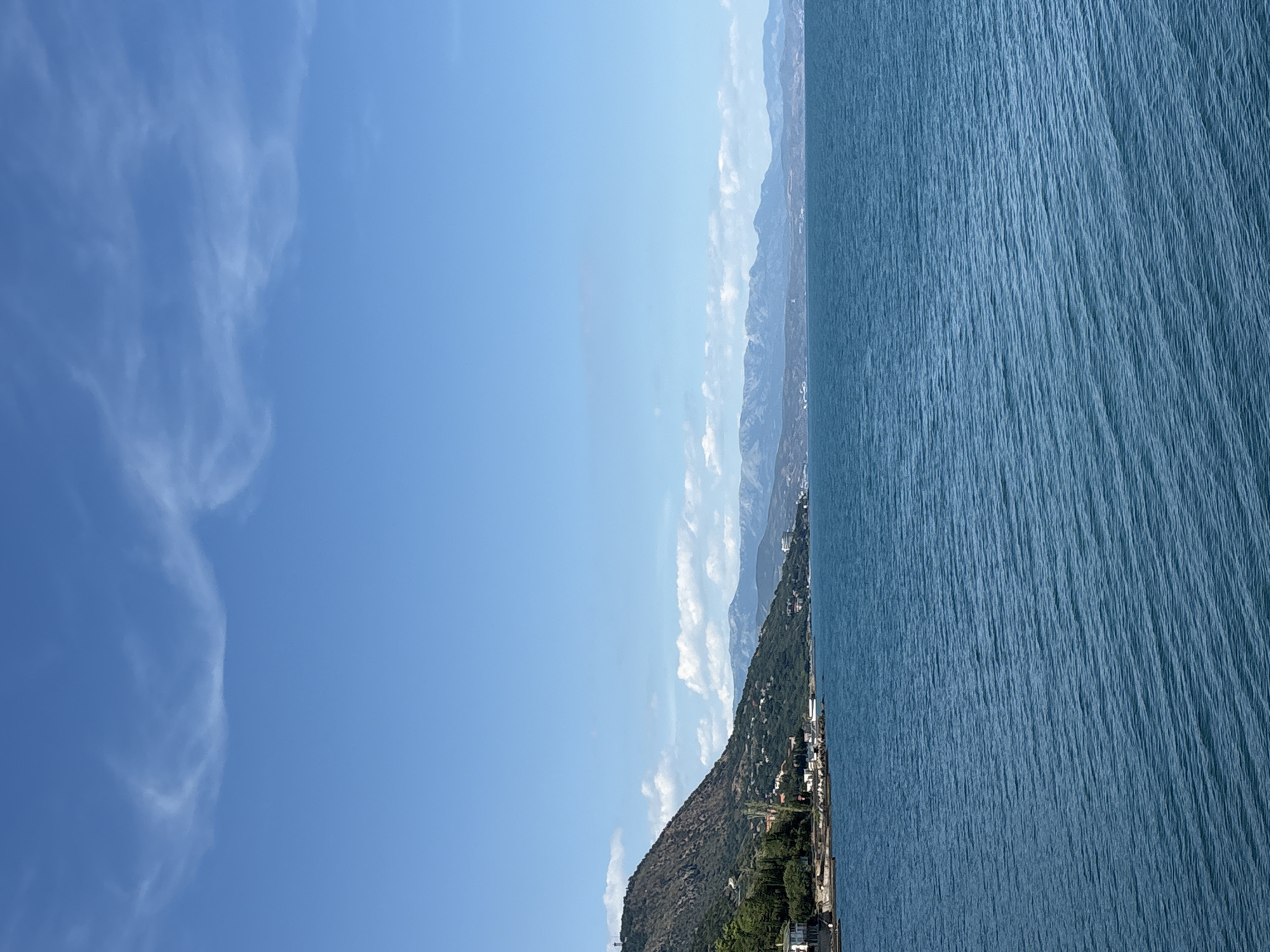 Calm coastline and hillside buildings along the Crimean shore