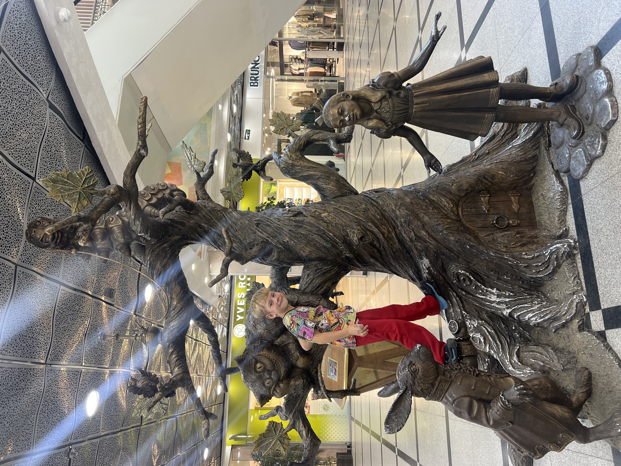 Boy climbs Alice in Wonderland sculpture in Yekaterinburg