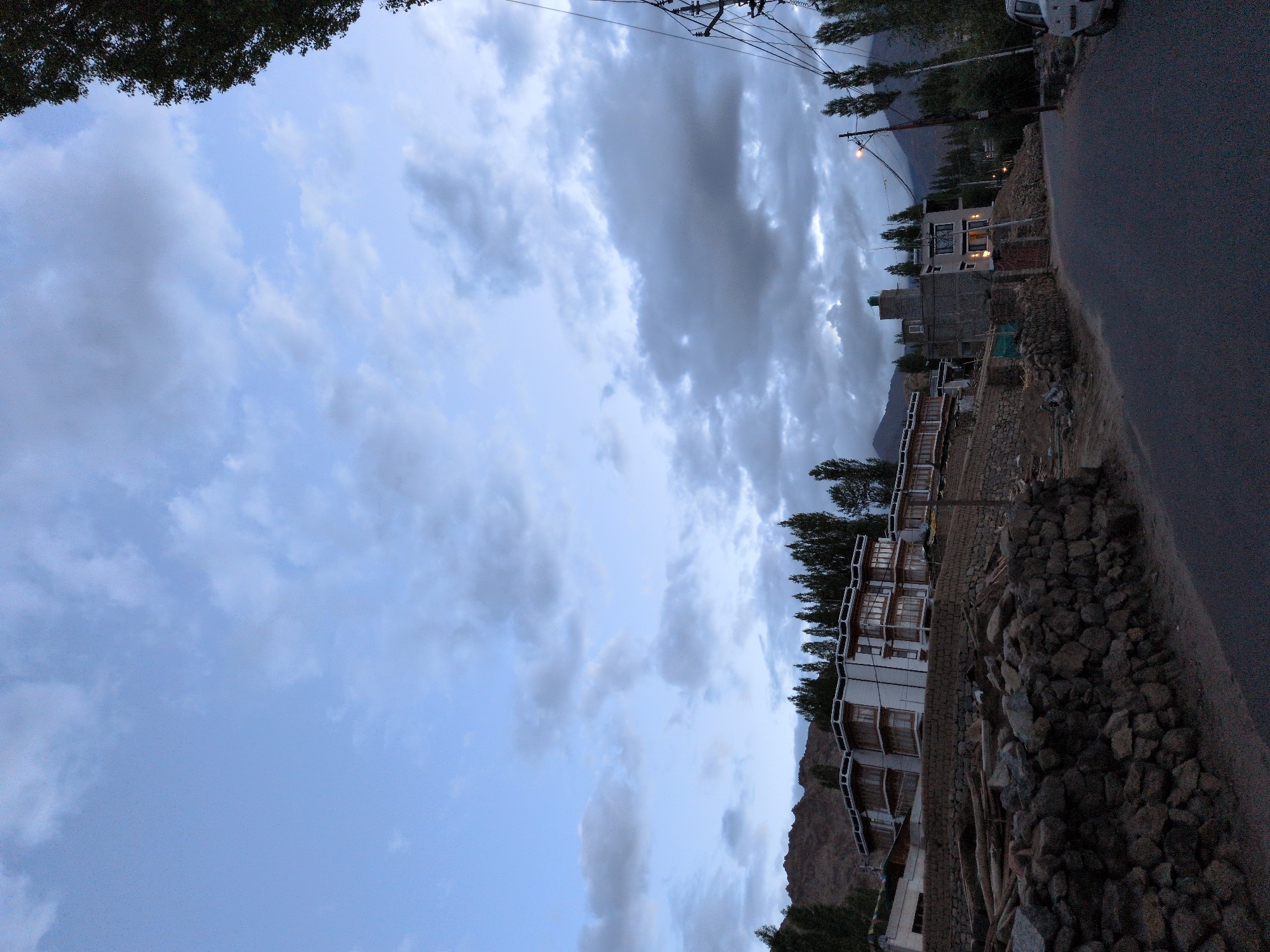 Leh at dusk: stone walls, white buildings, twilight hills