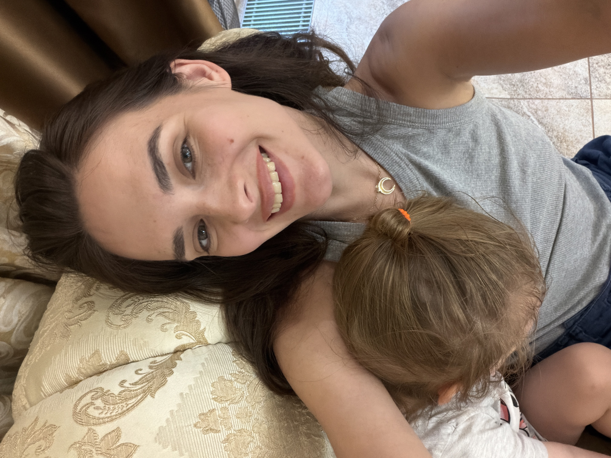 Relaxed couch selfie in Ufa, gold crescent necklace detail